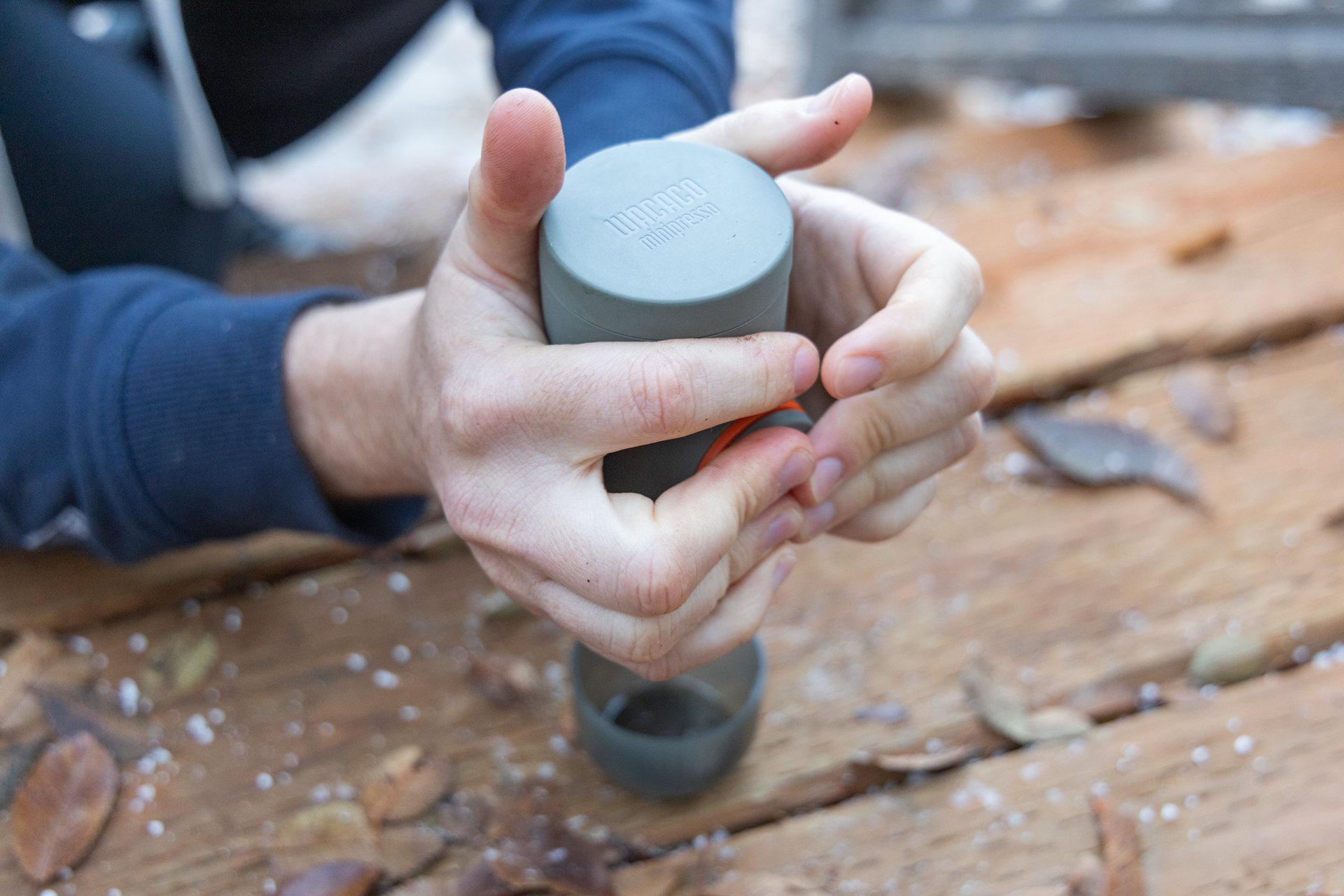Extracting a shot of espresso with the Wacaco Minipresso by squeezing the pressure wand with your hands.