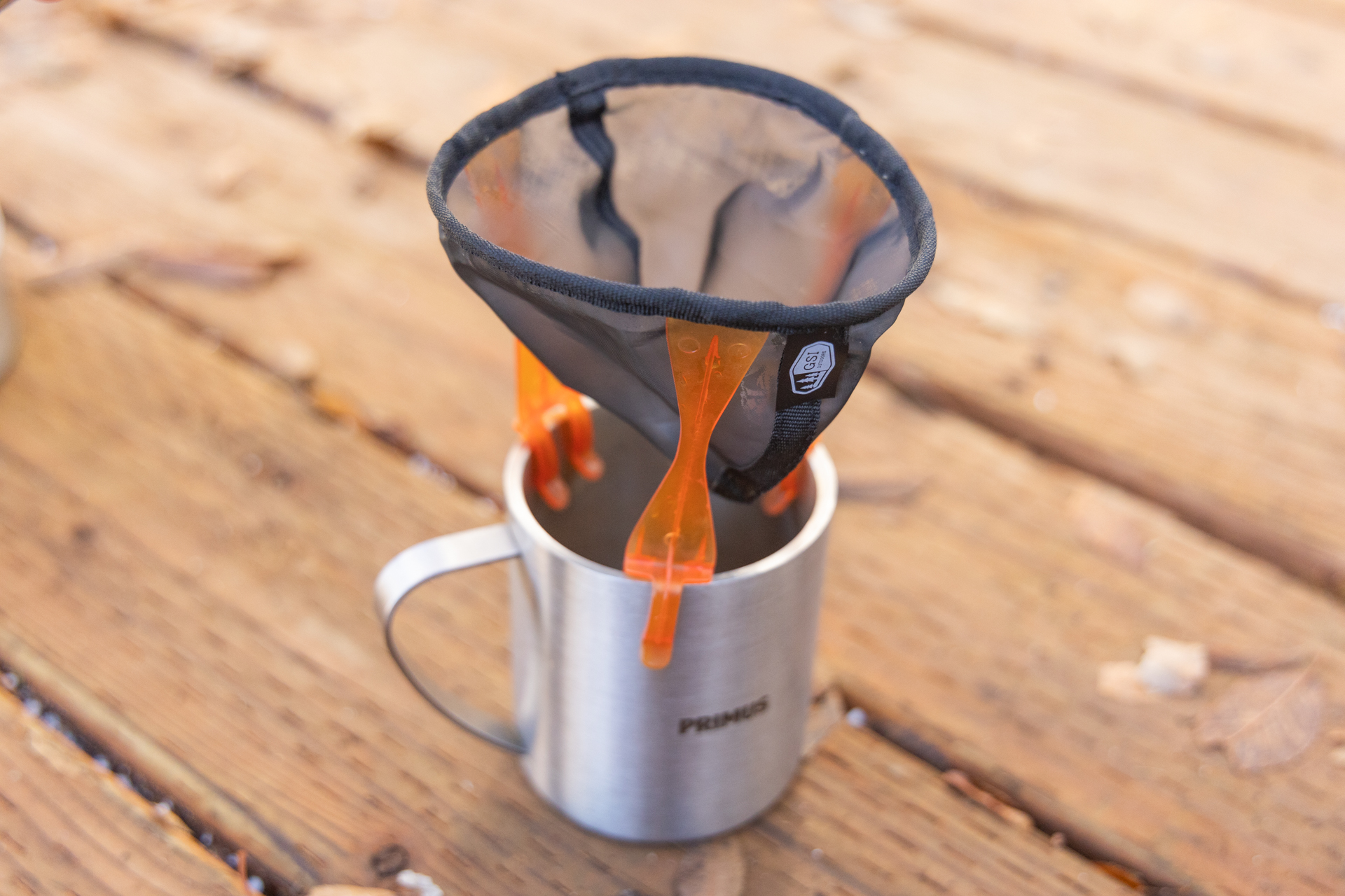 The GSI Ultralight Java Drip clipped onto a camp mug.