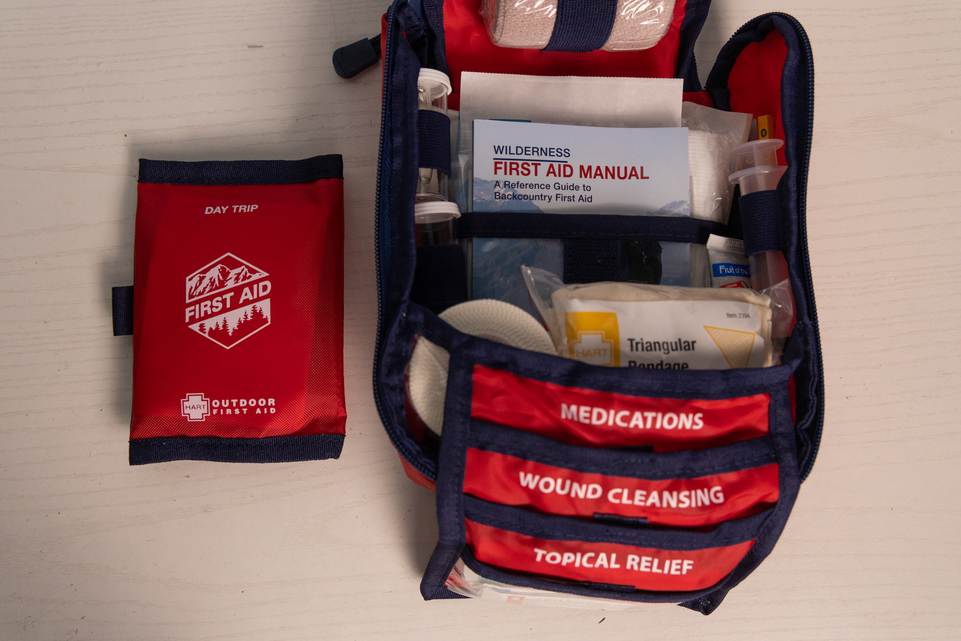 The HART Extended kit has a fold-out wing with more labeled organizational pockets plus a removeable day hike kit.