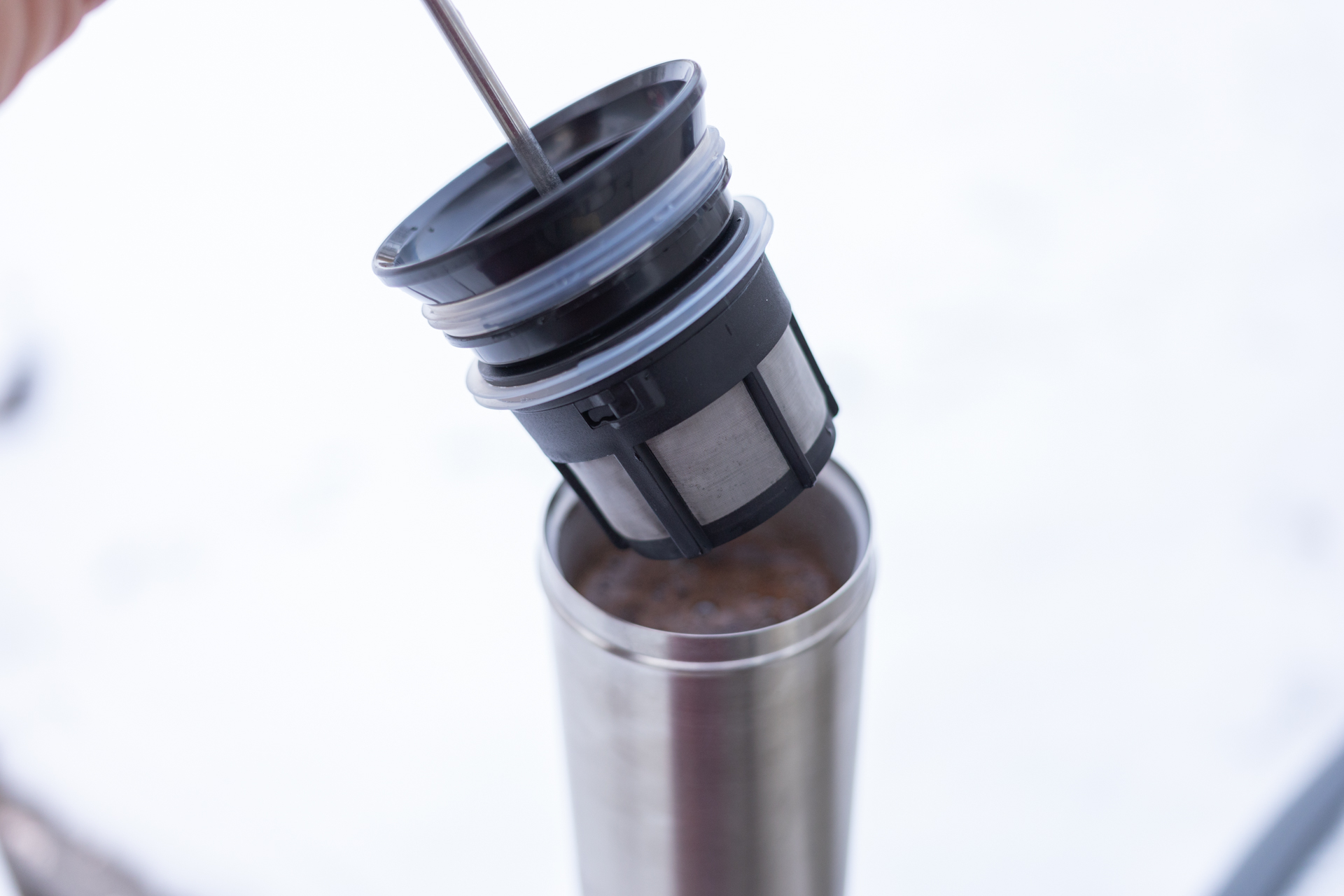 The ESPRO filter hovering above a full mug.
