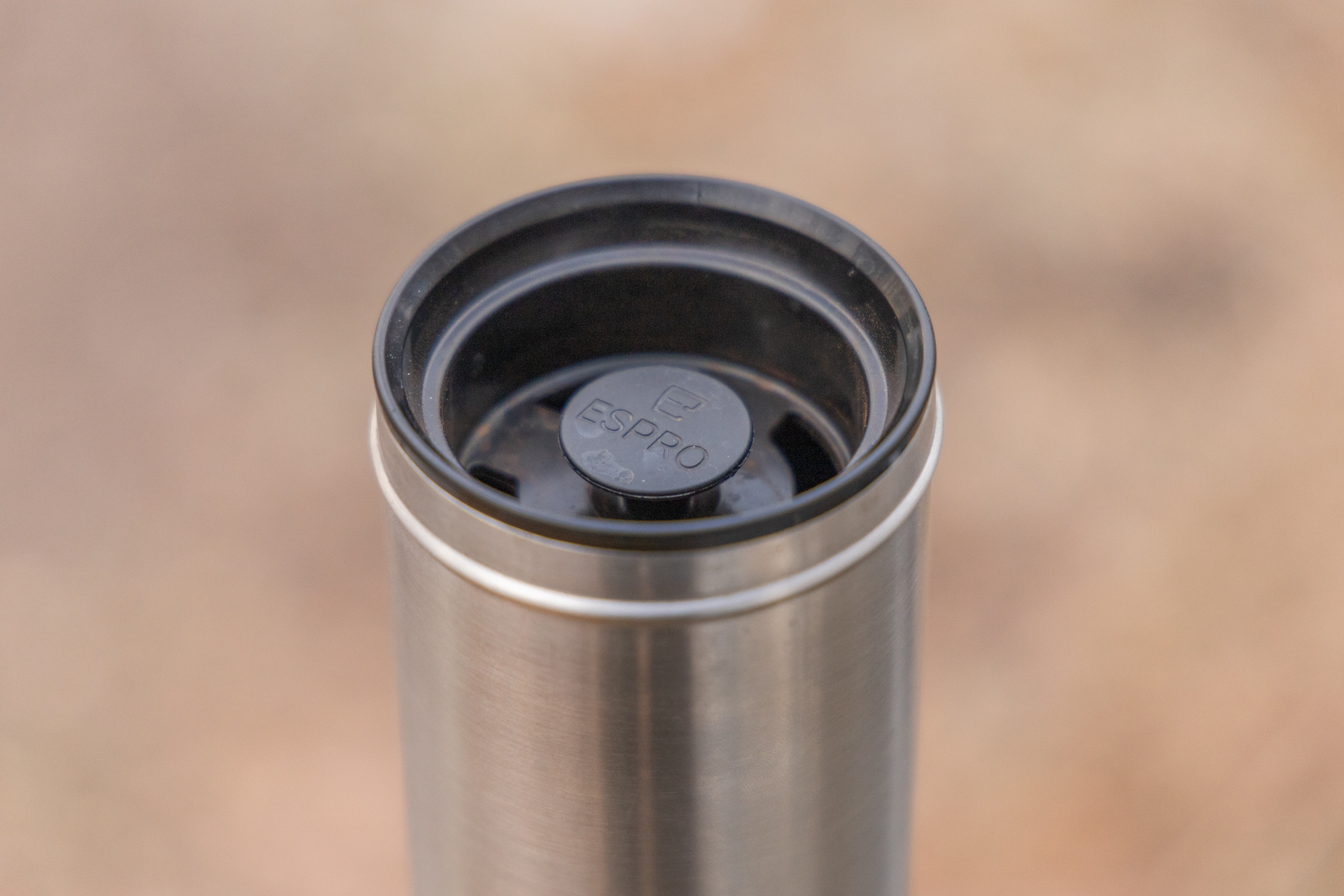 A view of the ESPRO interior lid and depressed plunger. There are holes around the lid for drinking.