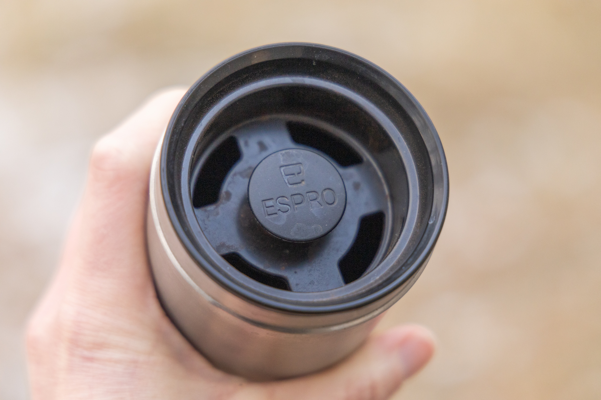 A view of the ESPRO interior lid and depressed plunger. There are holes around the lid for drinking.