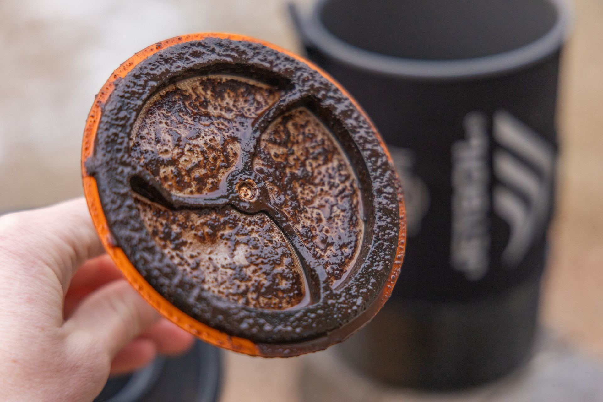 A dirty Jetboil Silicone Coffee Press covered in grounds.