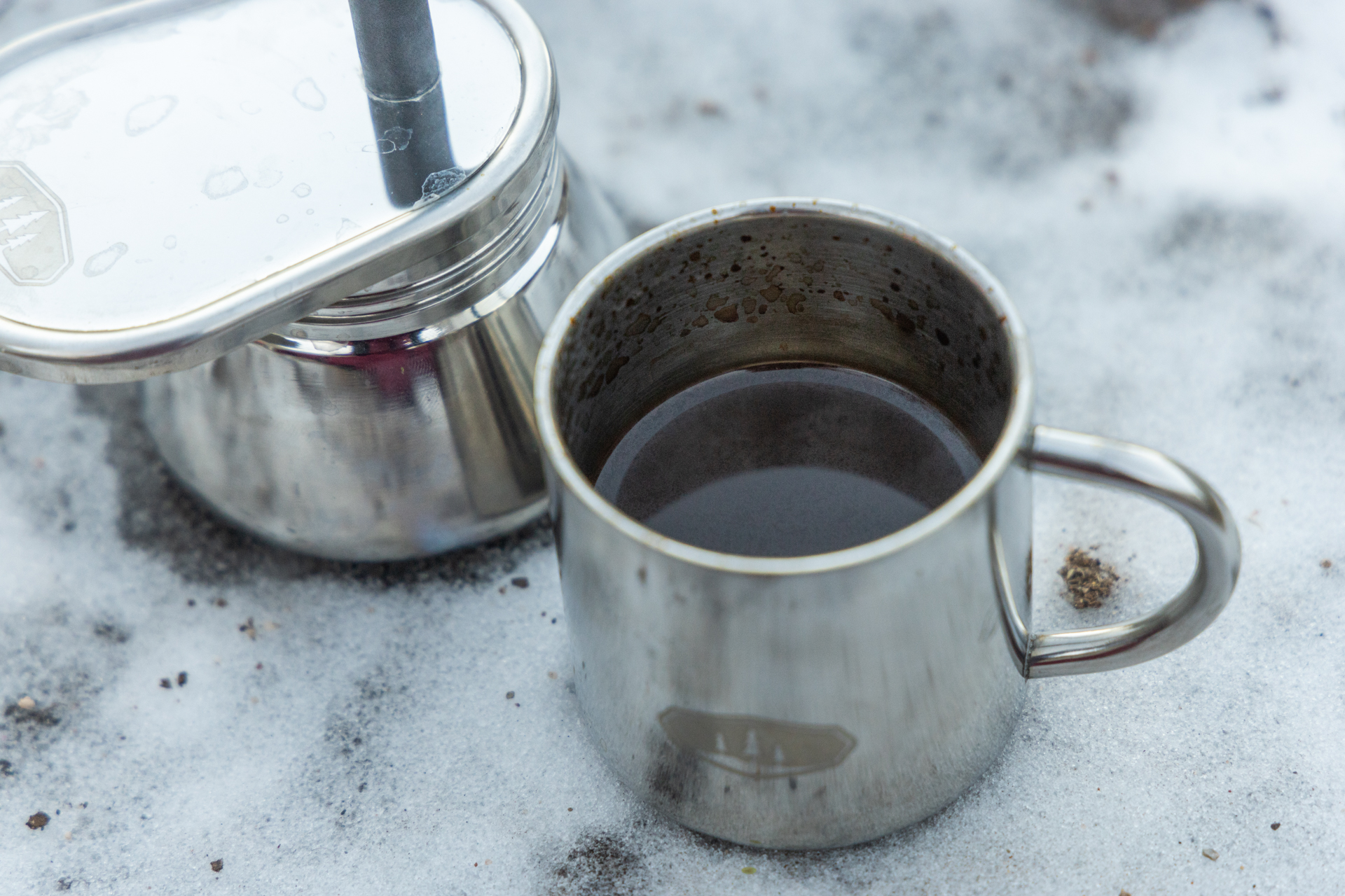 A small cup full of coffee from next to the GSI Mini Espresso.
