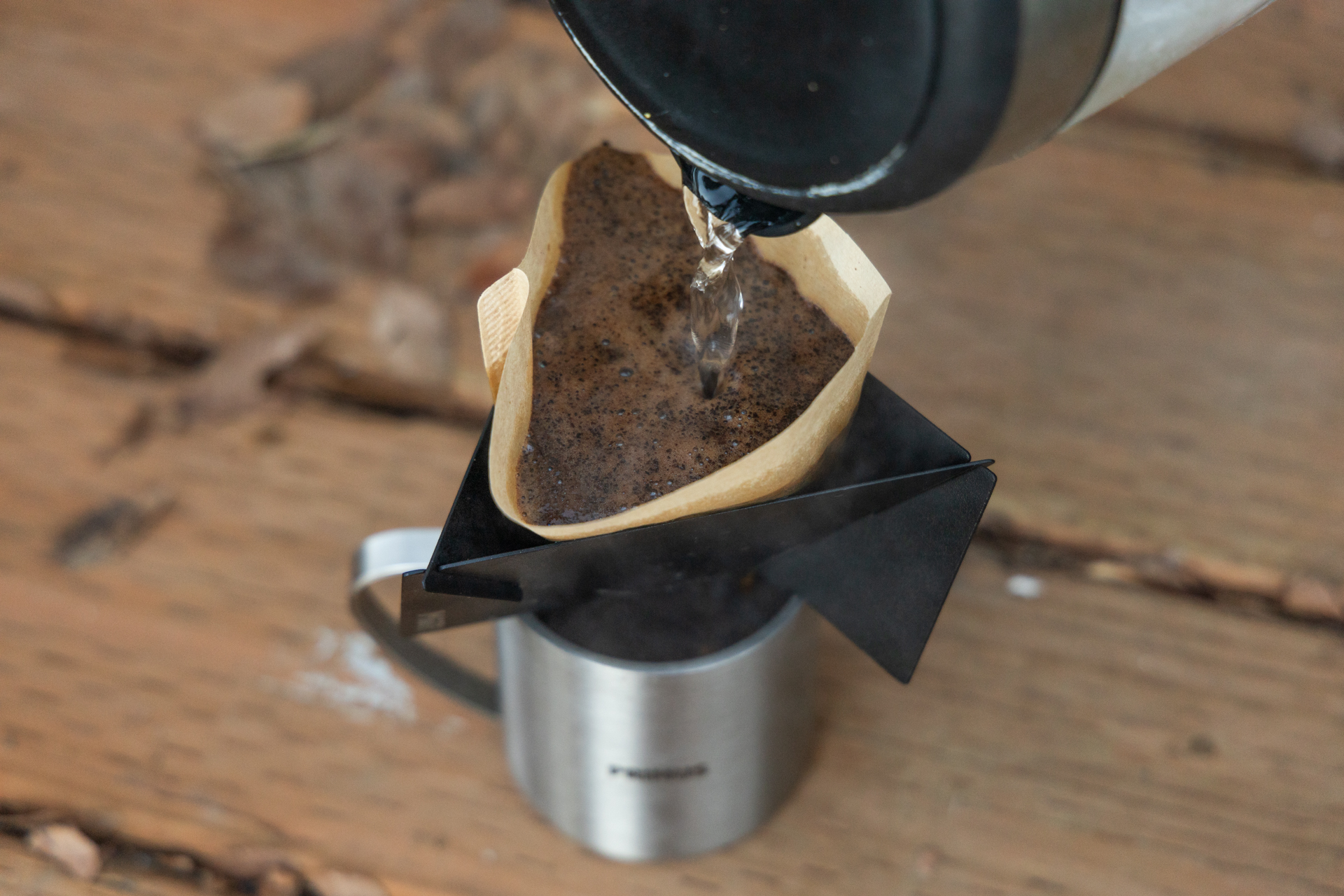 Pouring water into a filter with grounds inside the MiiR Pourigami.