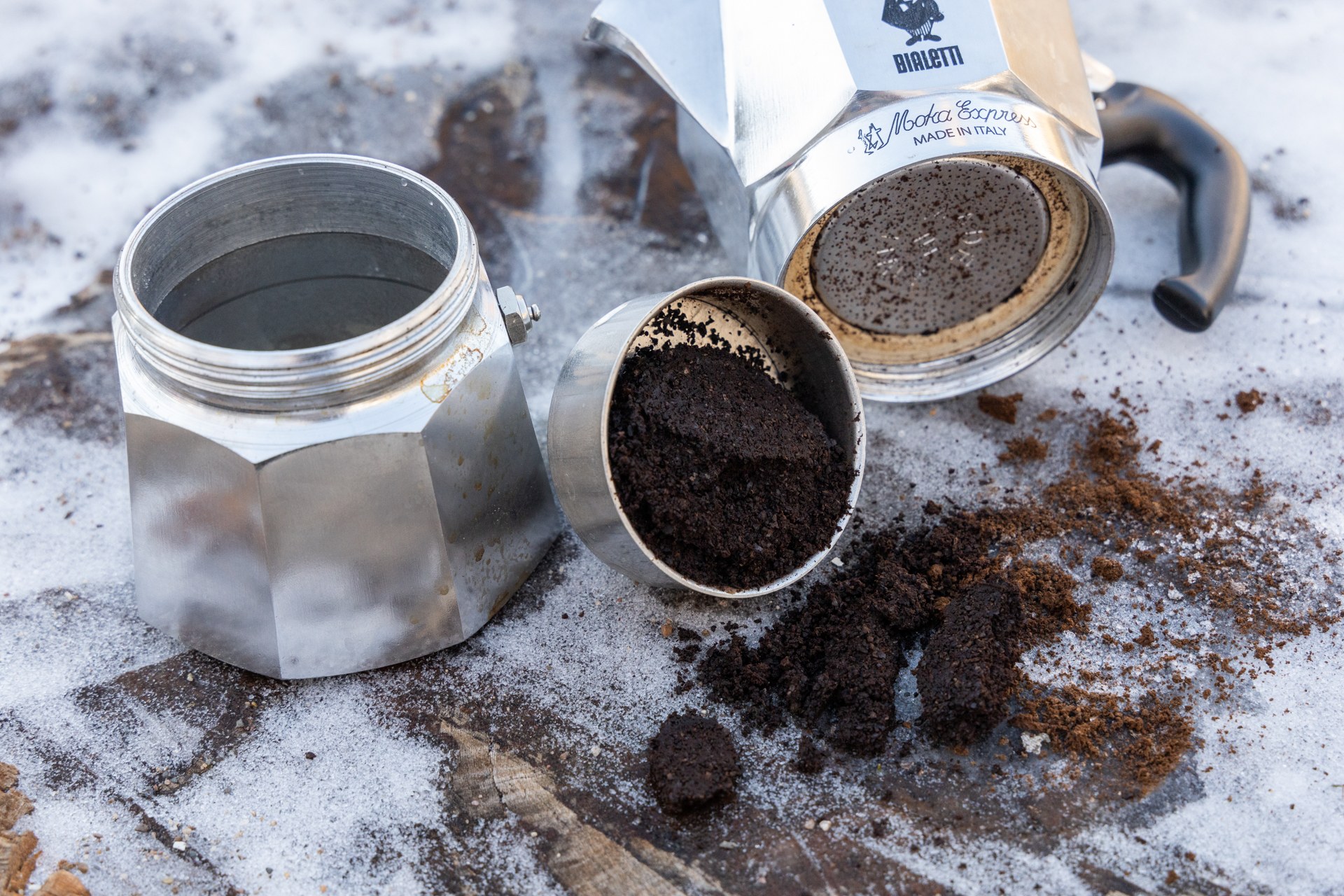 The Bialetti Moka Express disassembled to see coffee grounds and cleanup required.