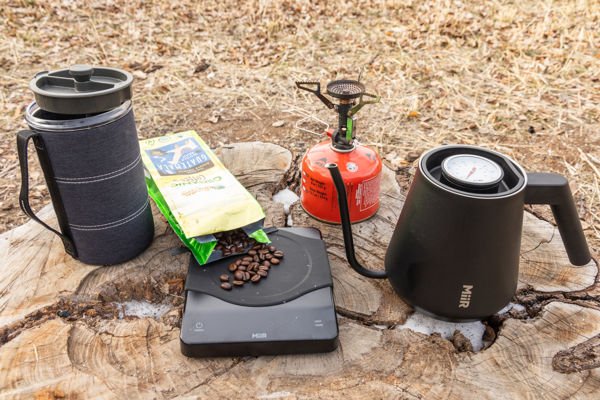 Coffee beans, a MiiR kettle and digital scale, GSI Java Press and backpacking stove.