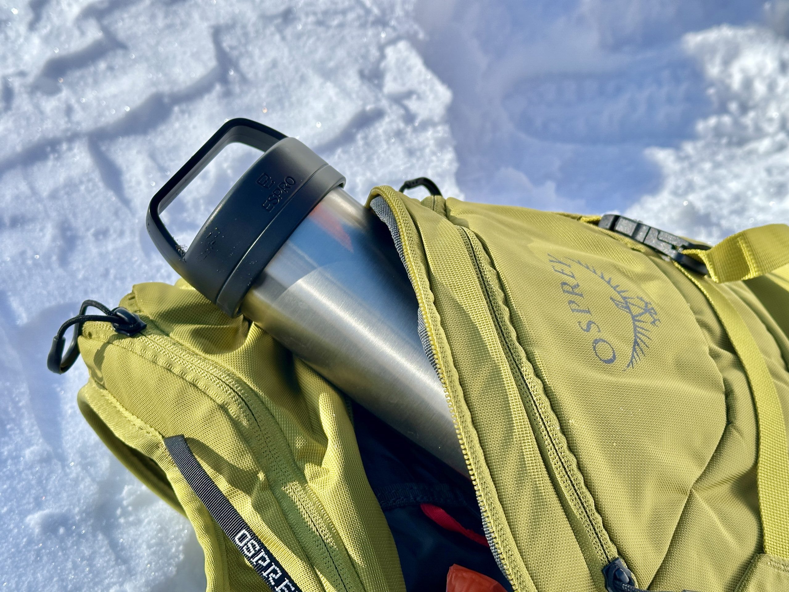 An ESPRO Bottle sticking out of a backpack.