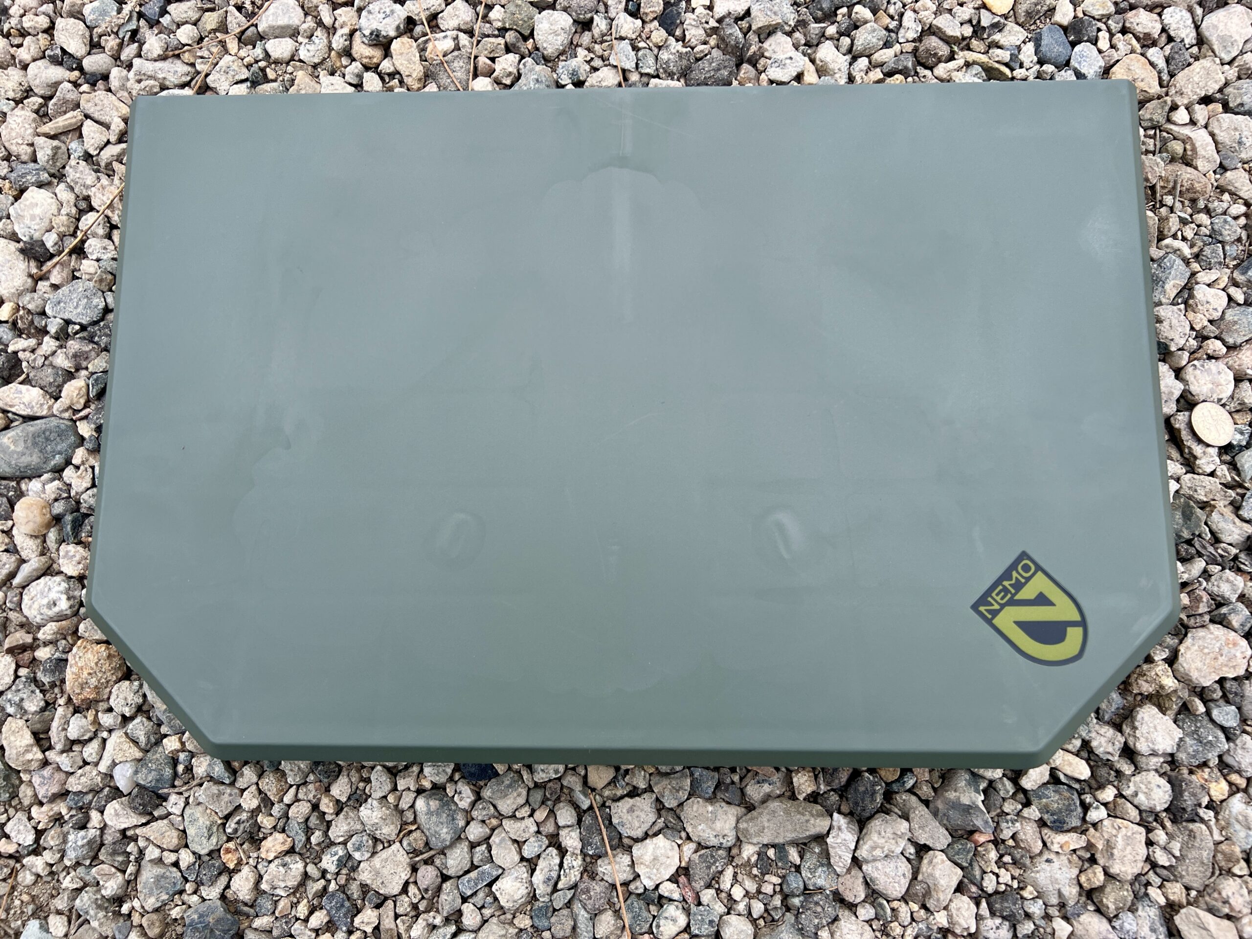 The NEMO Moonlander Dual-Height Table sits with its legs folded up on rocky ground.