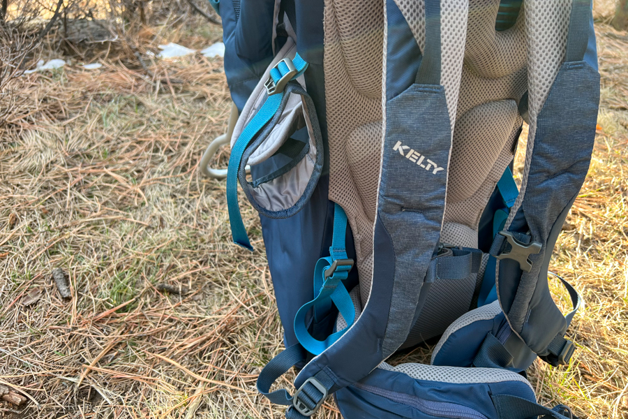 Back panel of the baby carrier showcasing padded straps and the Kelty logo for comfort and support.