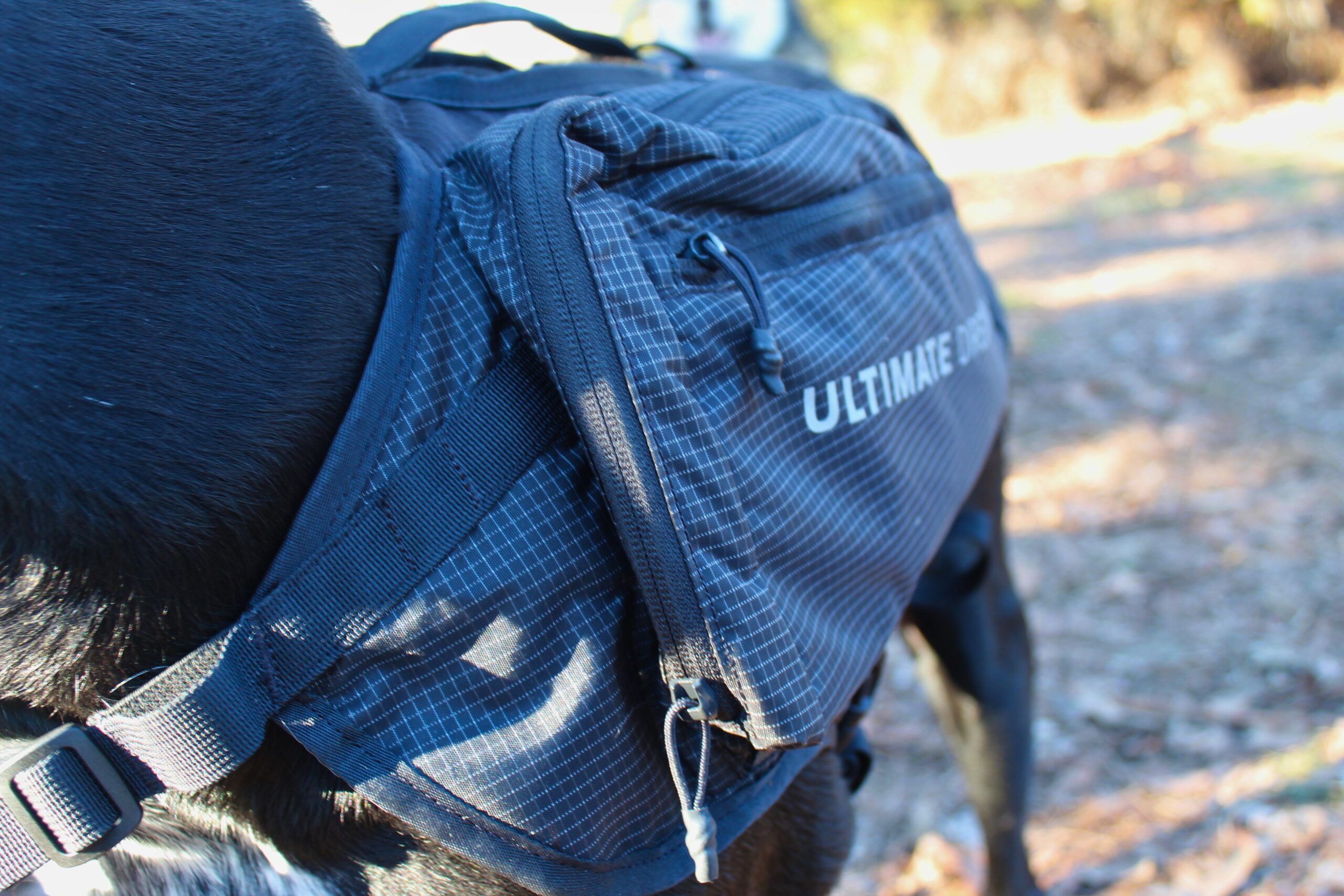 Close up of the Ultimate Direction Dog Vest zippers on one saddlebag
