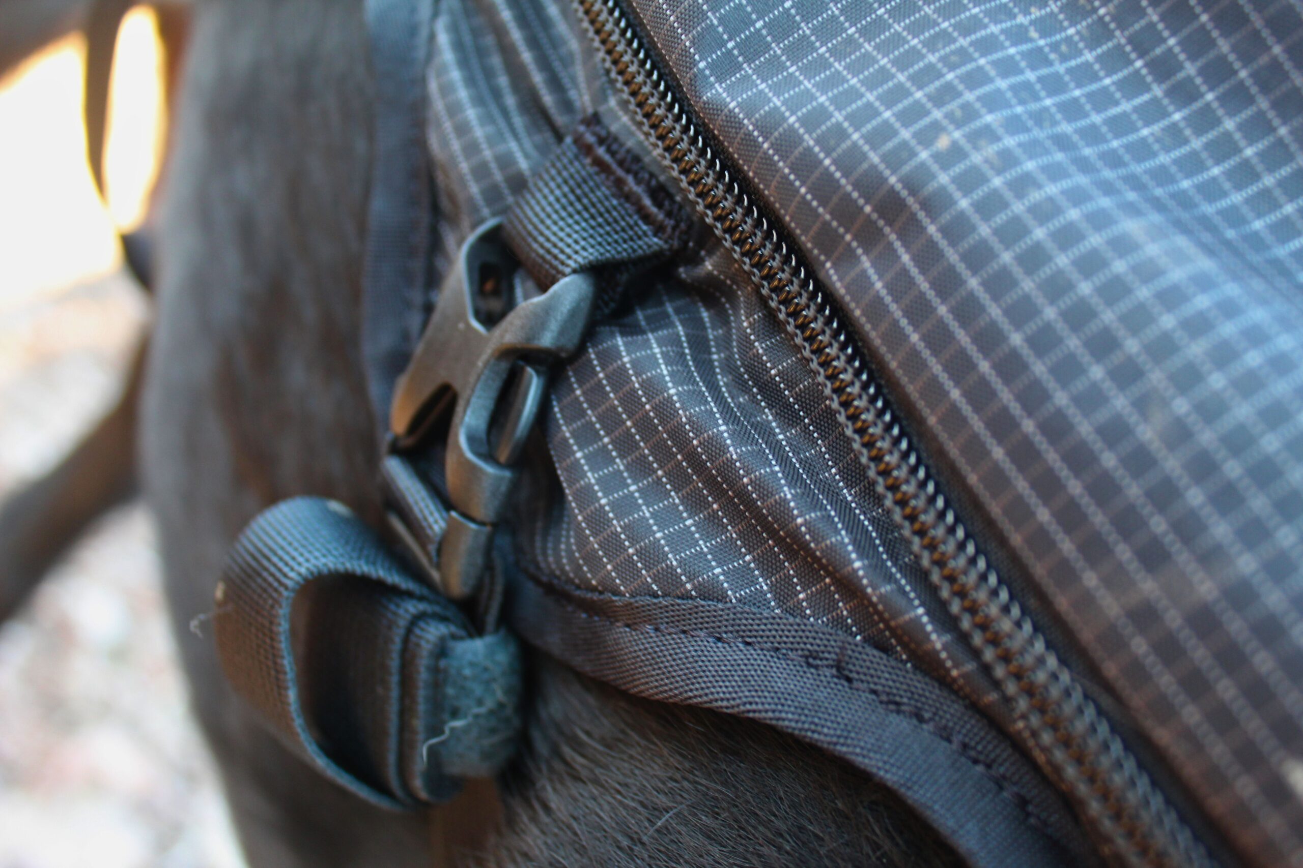 Close up of the Ultimate Direction Dog Vest buckles and strap saver