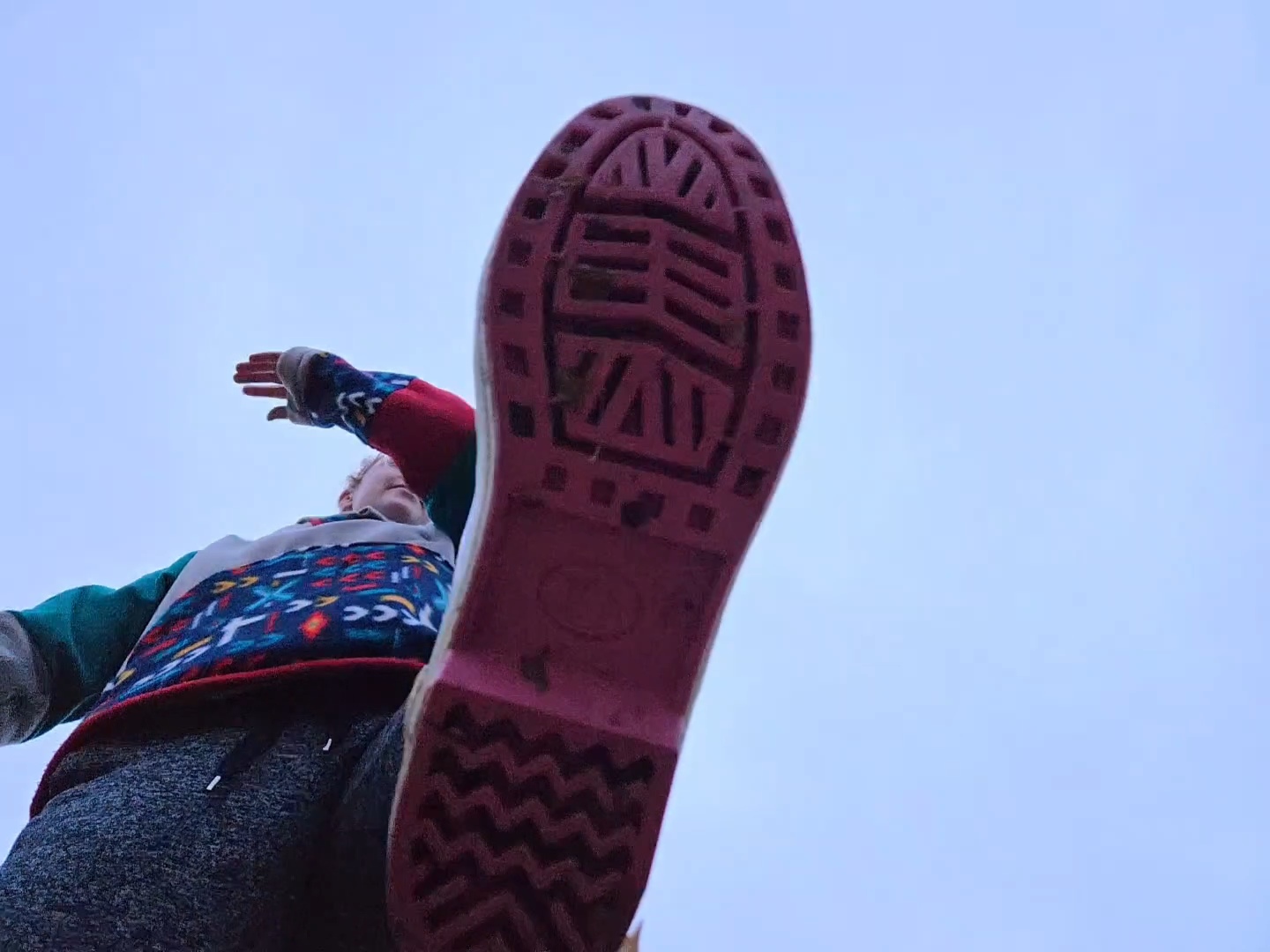 Looking up at the tread of the Xtratuf Legacy 15" rain boot. The outsole is pink.
