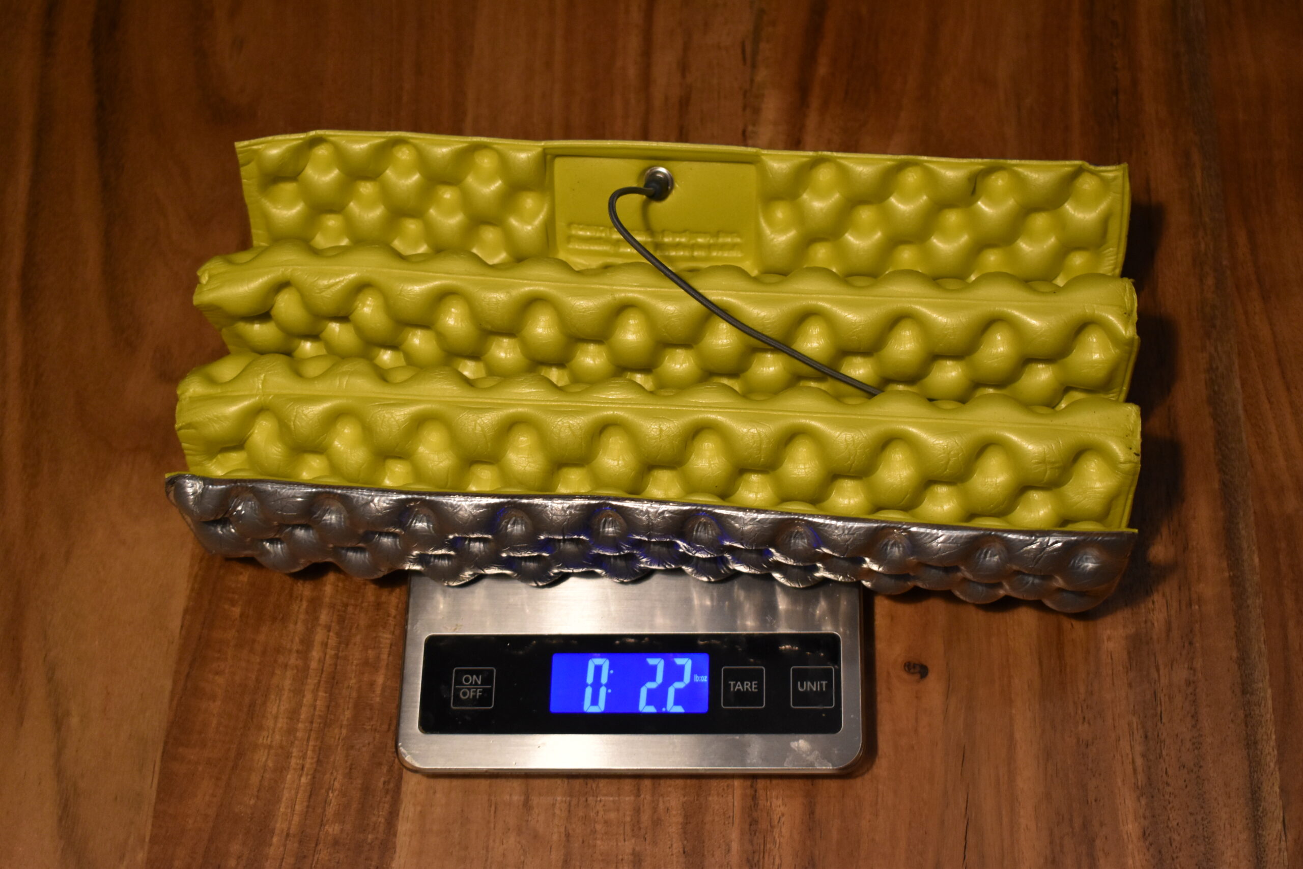The Z-Seat pad sits on a kitchen scale that reads 2.2 ounces