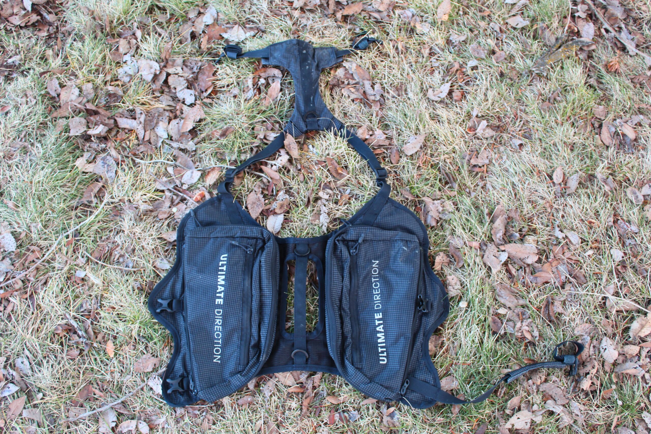 The Ultimate Direction Dog Vest laid out on the ground
