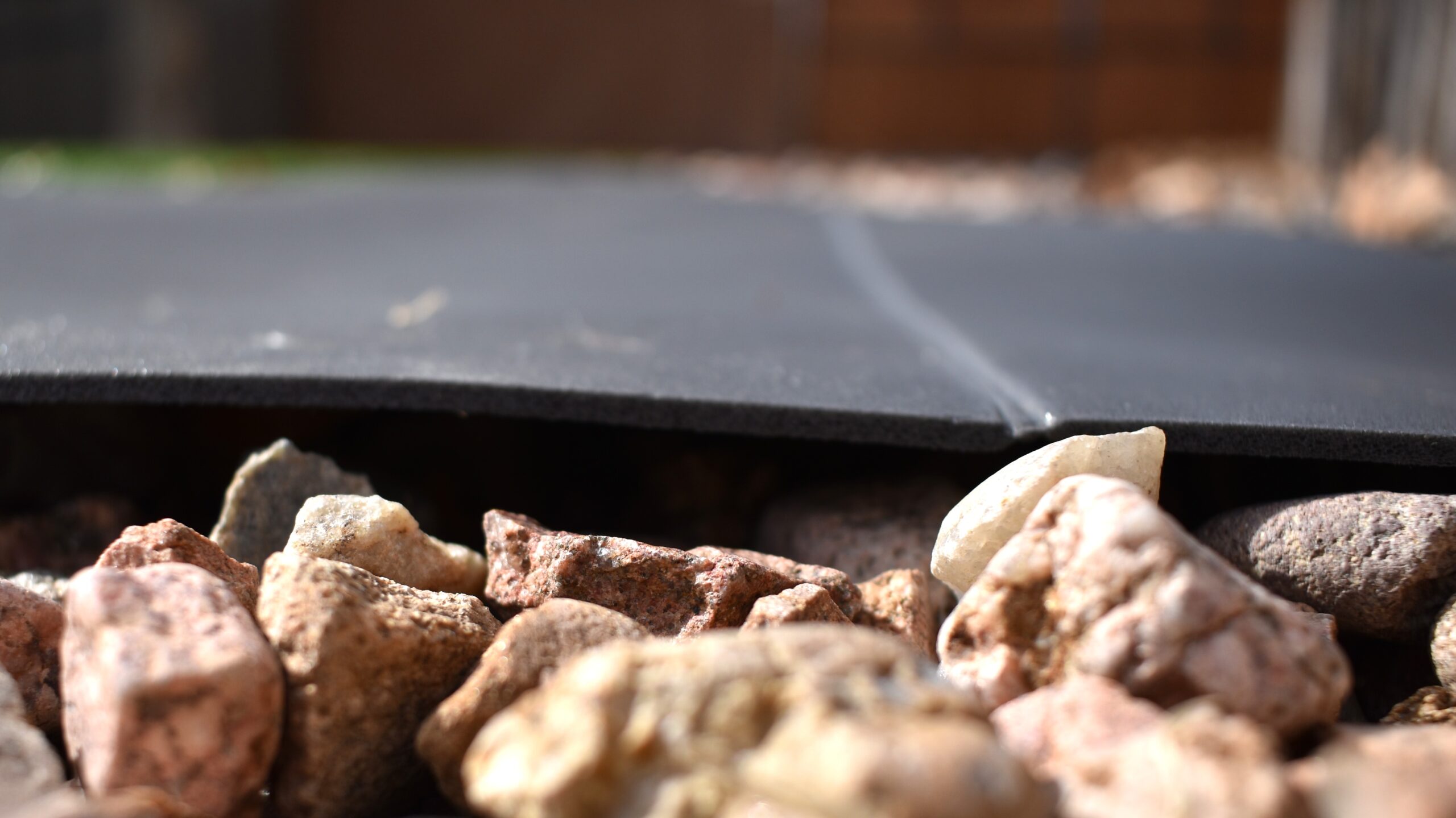 close up of the width of the Gossamer Gear pad laying on a bed of gravel