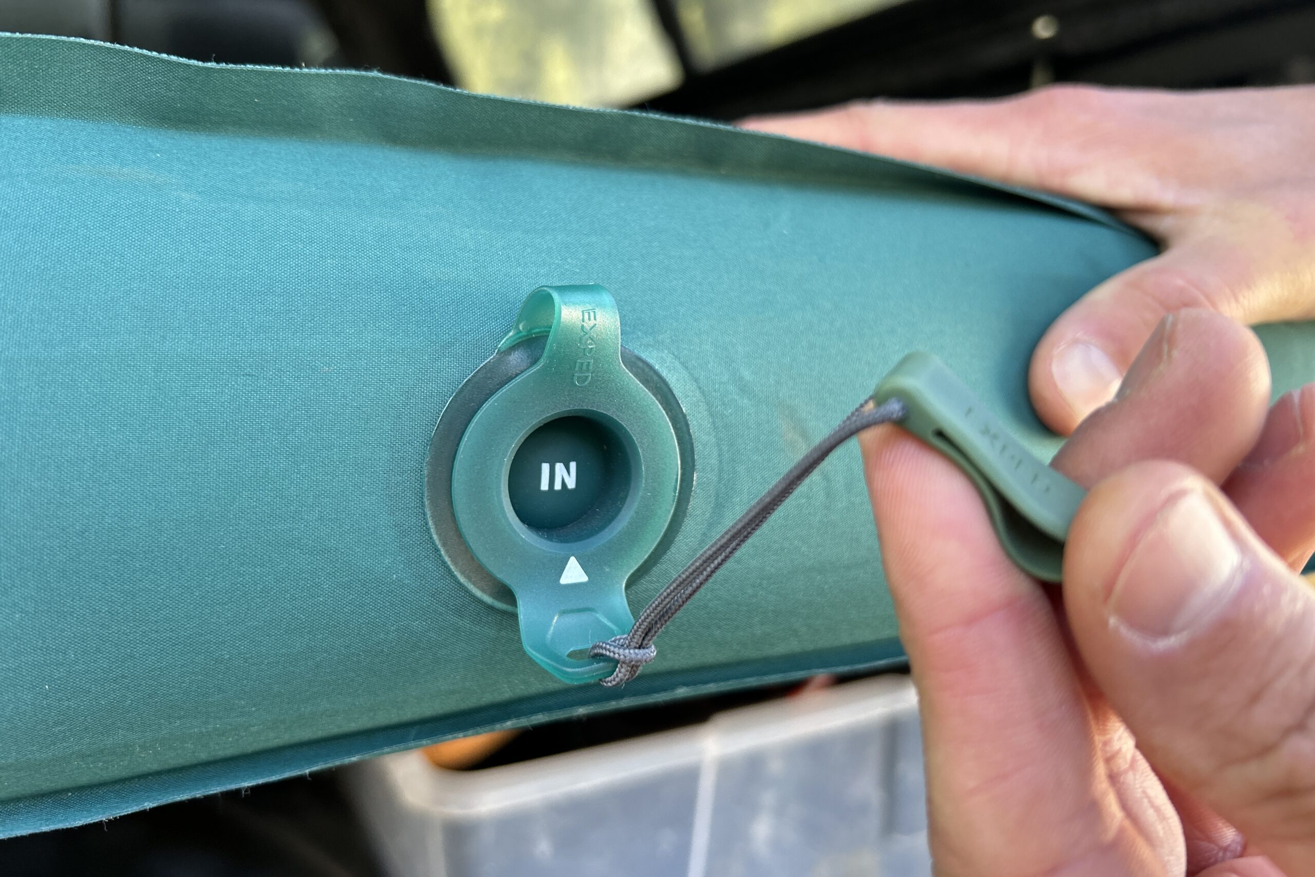 Close-up image of the inflation valve on a camping mattress.