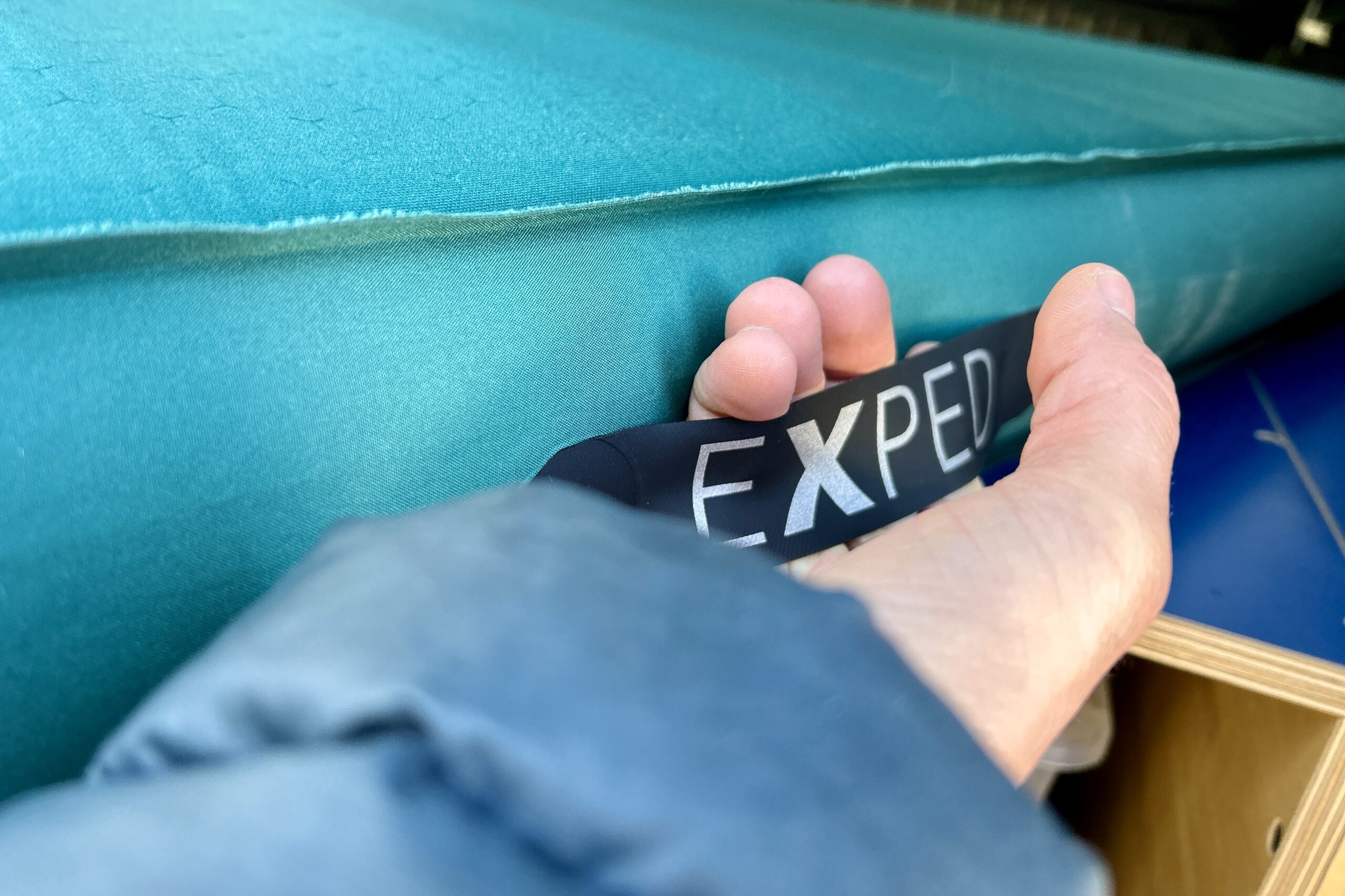 Close-up image of a handle on the side of a camping mattress.