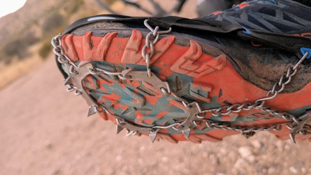 a close up of the toe of a pair of ice cleats on a sneaker