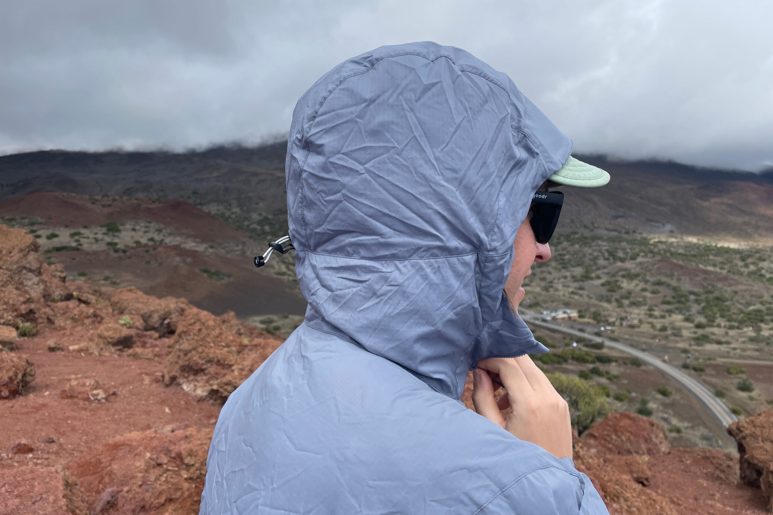 A man cinches the hood on his windbreaker.