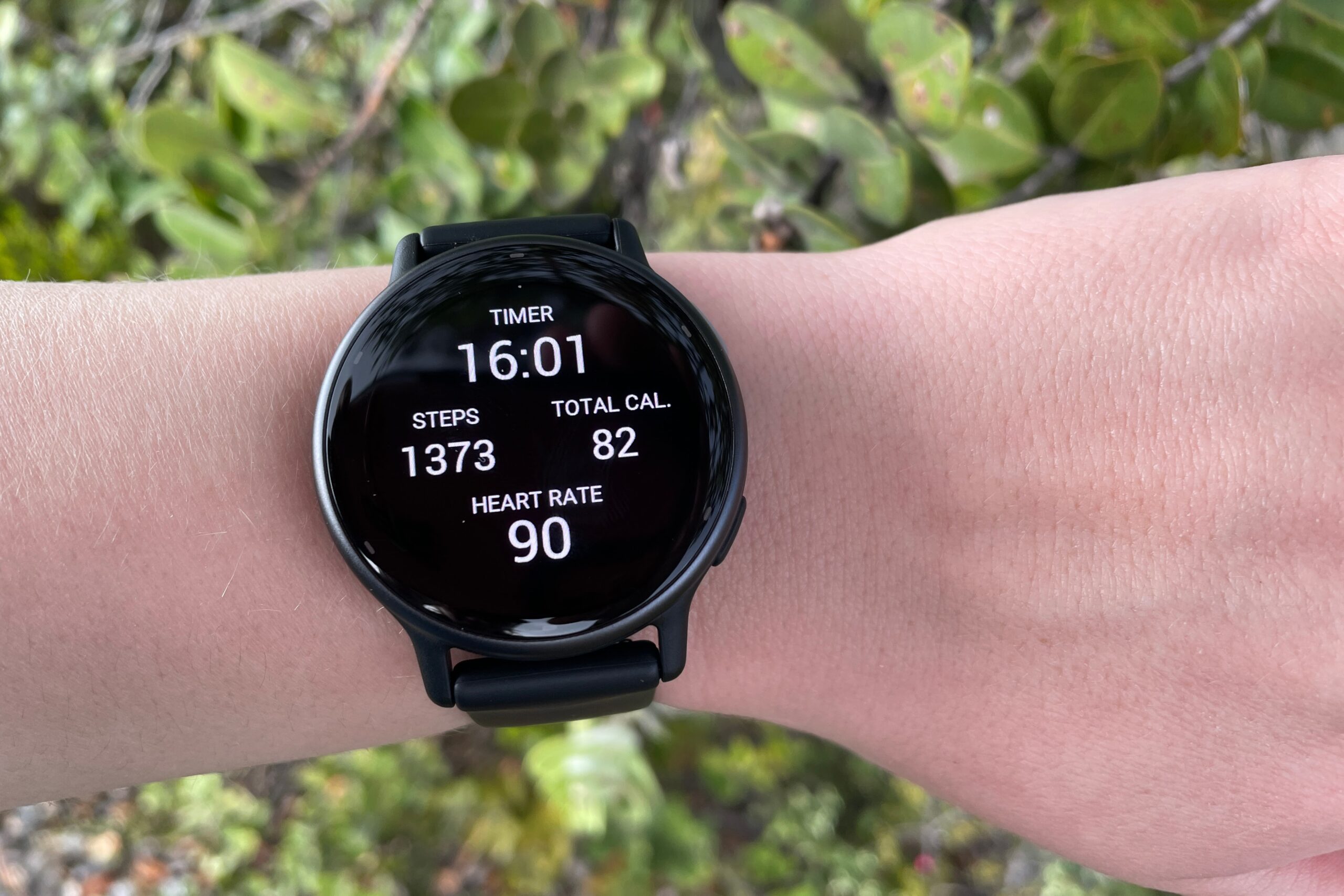 A closeup of a watch face worn on a wrist.