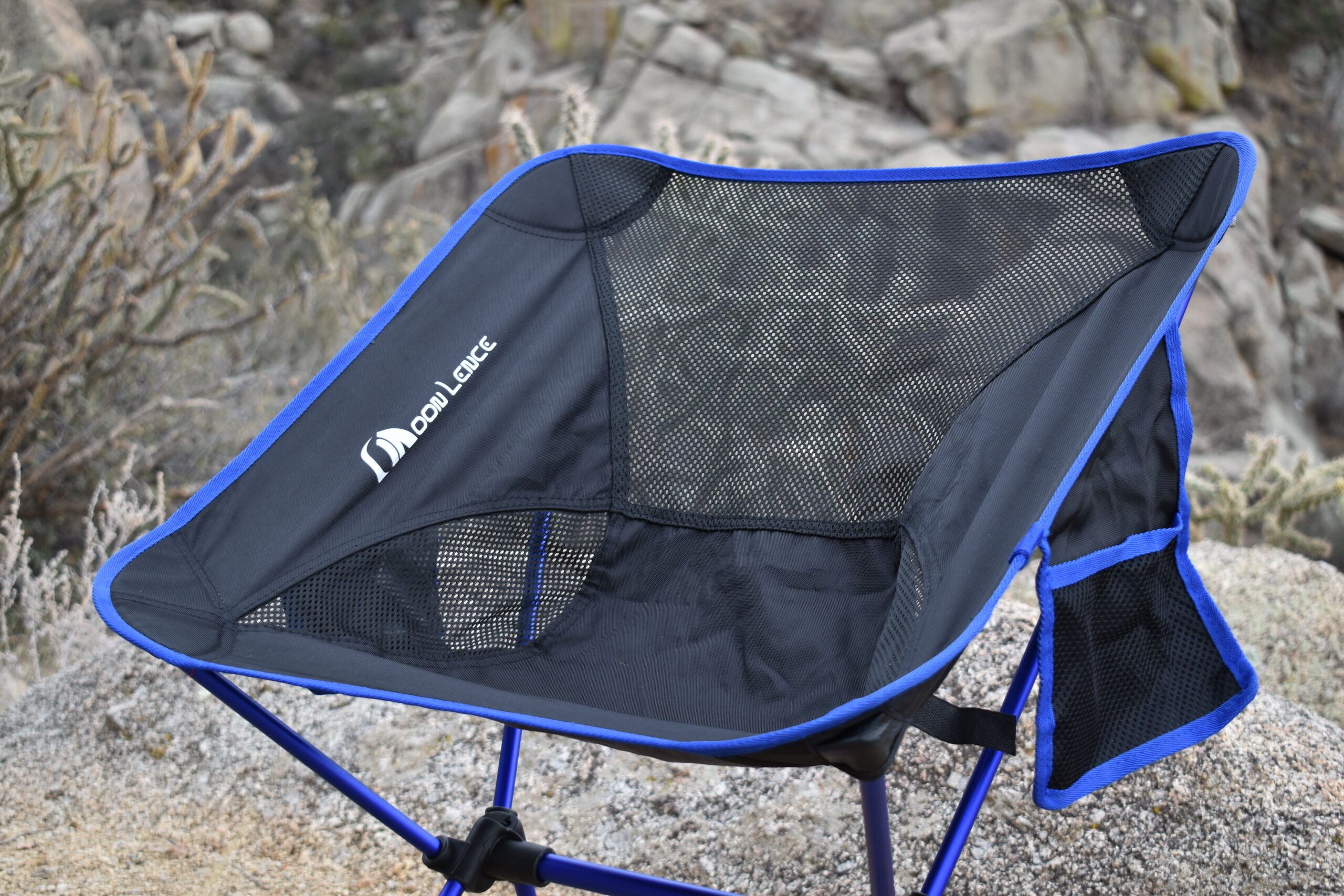 close up of the black fabric seat of the Moon Lence chair with side pockets hanging off the side