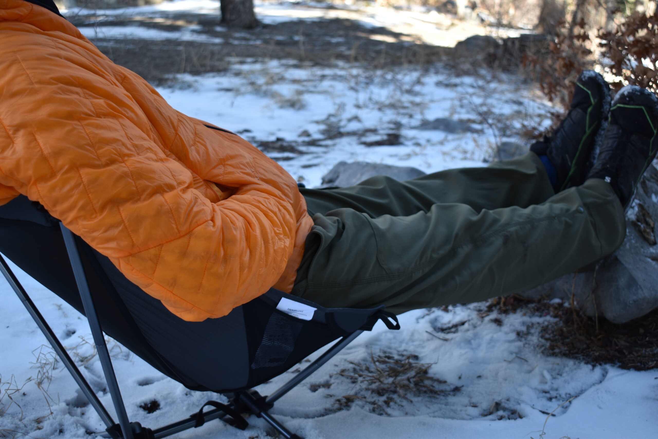 hiker extending his legs at camp while reclining in the Yizi-Lit chair