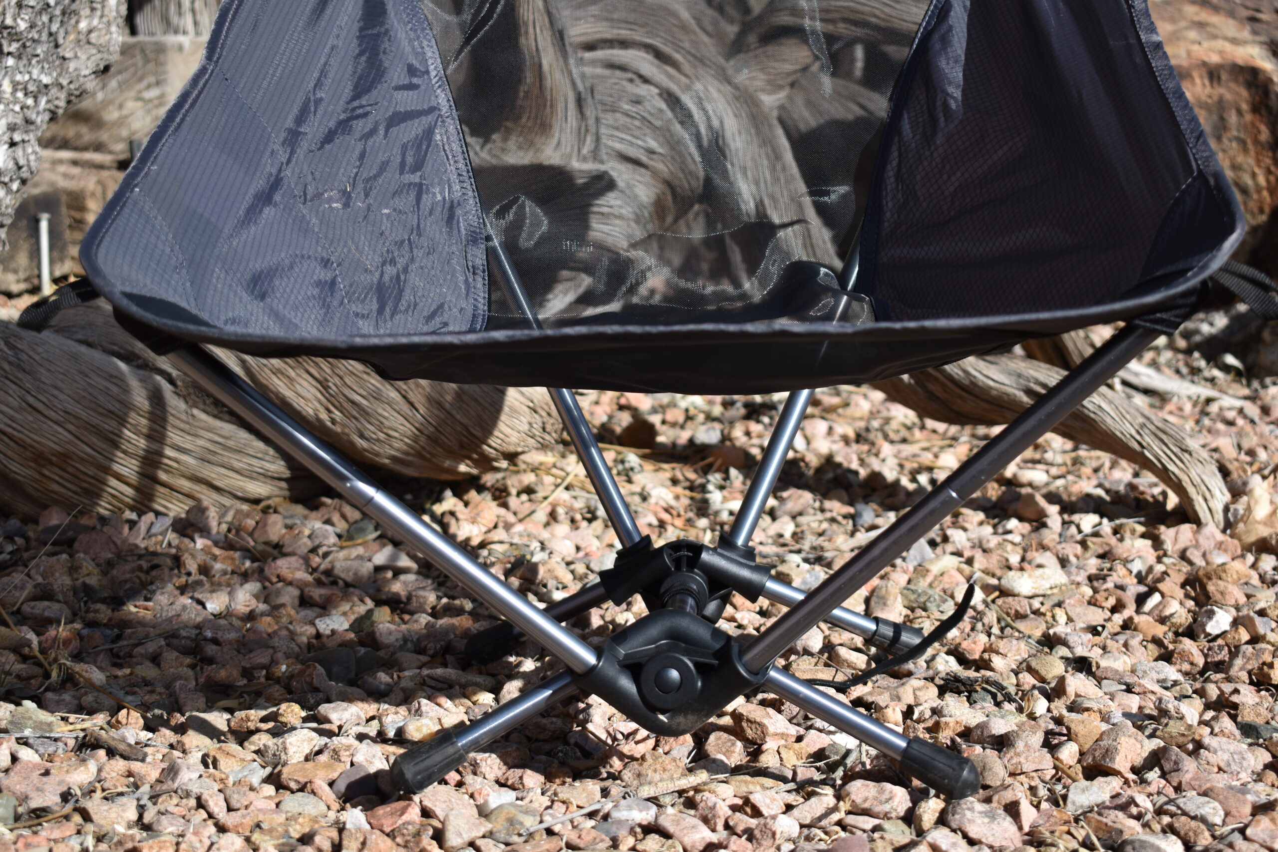 close up of the short legs, plastic hubs, and center pole of the Trekology backpacking chair