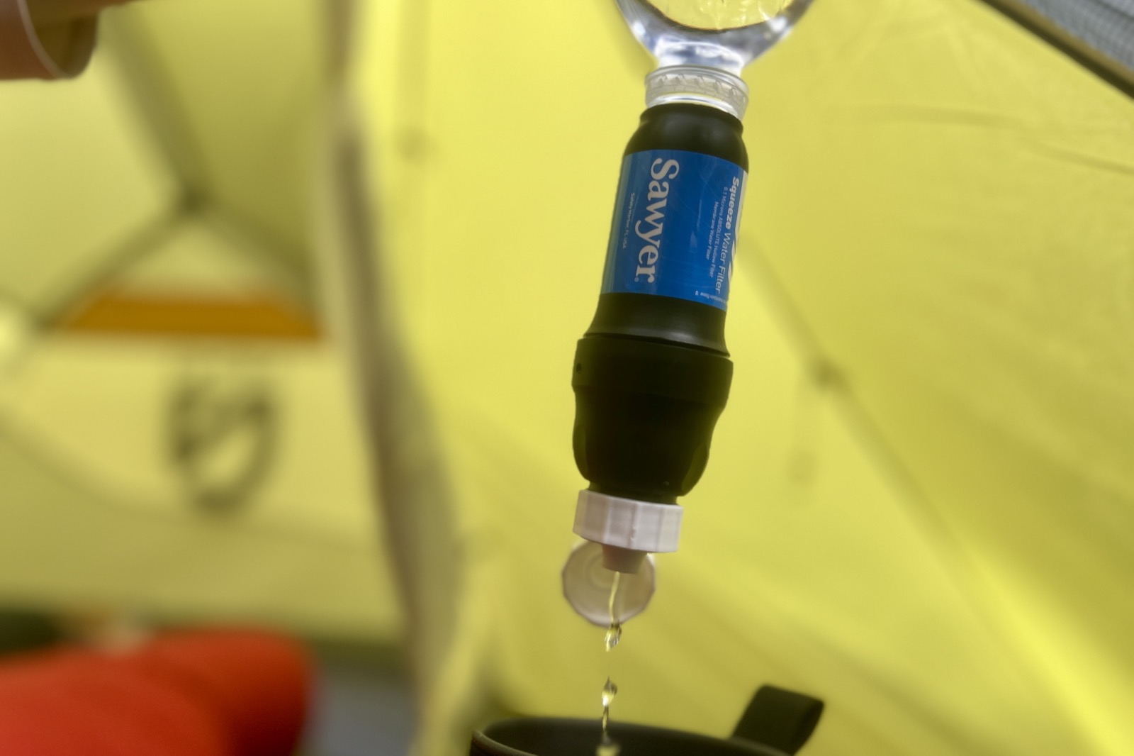 a close up of water being squeezed through the sawyer squeeze