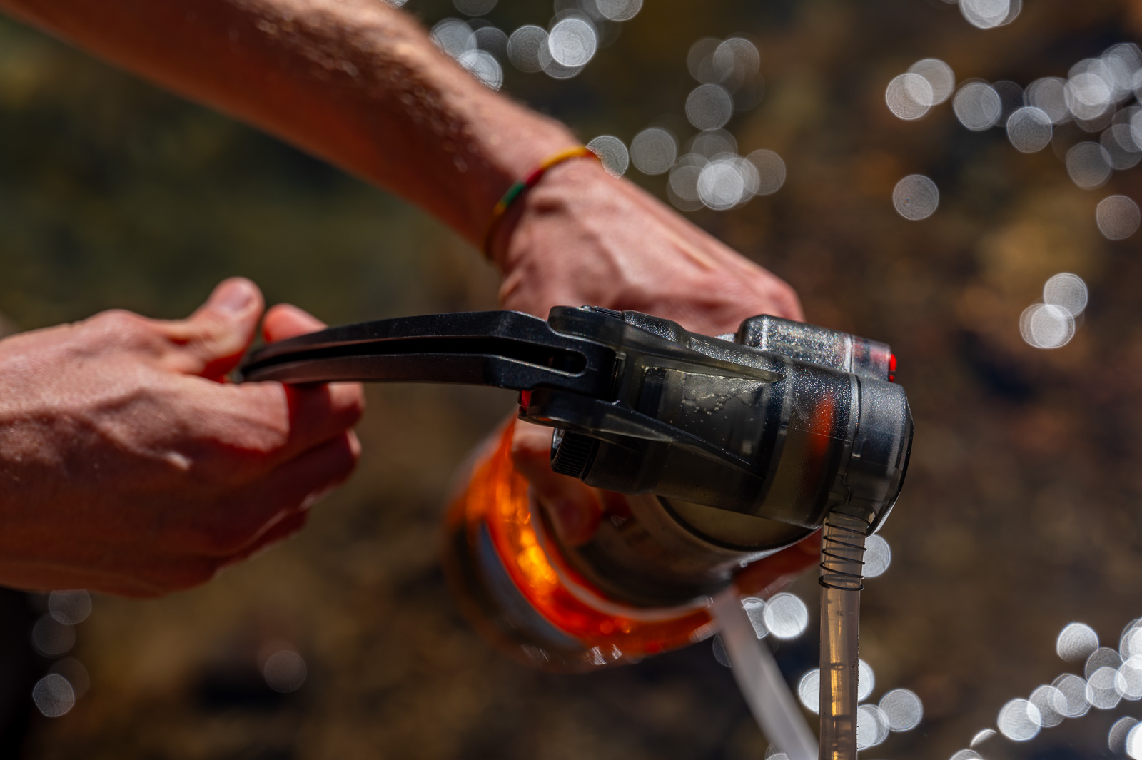 A close up of the top of the msr guardian filter being pumped by a hiker