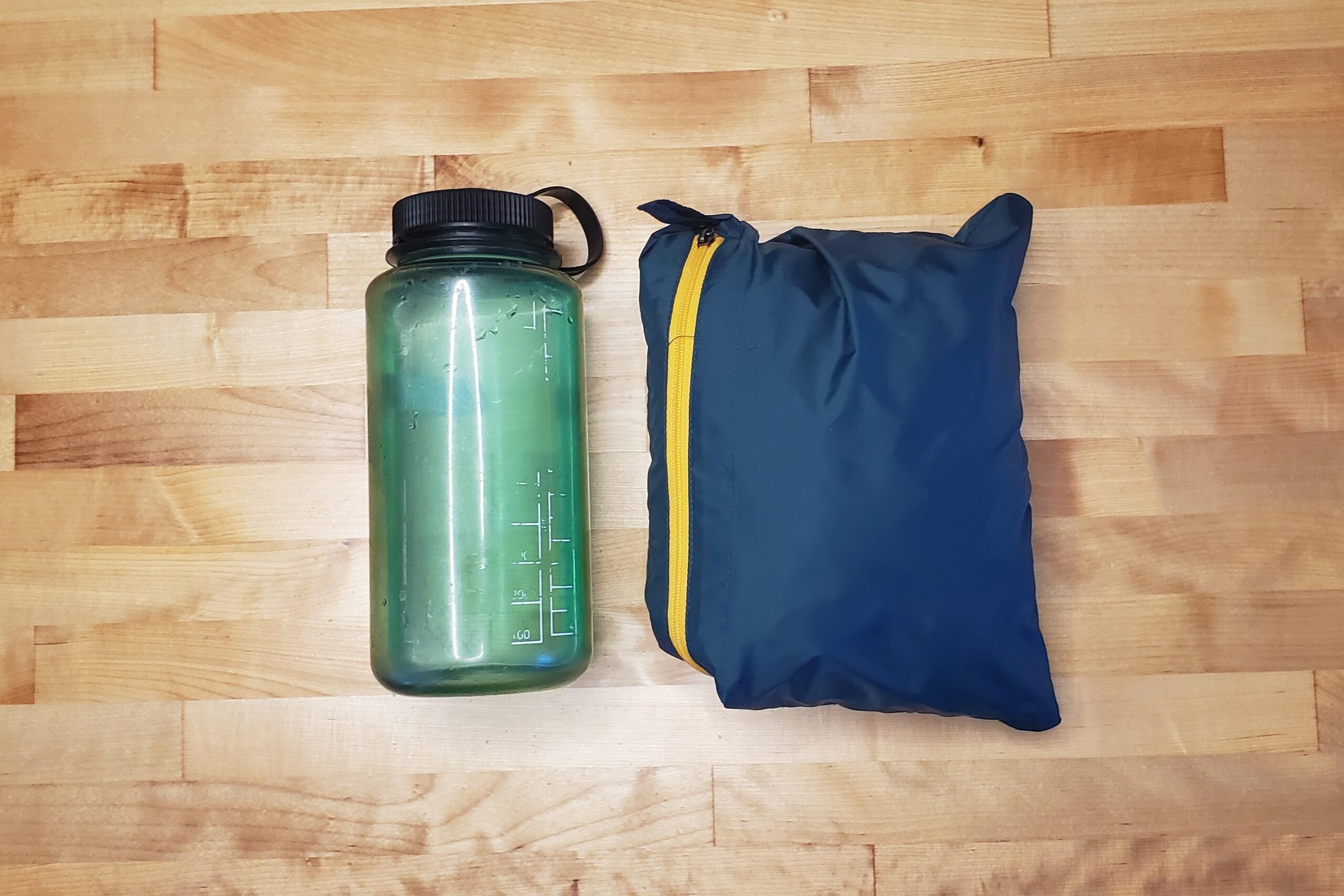 A windbreaker packed down compared to a one liter bottle.