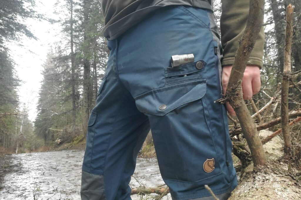 A closeup of a unique pocket on a pair of pants.