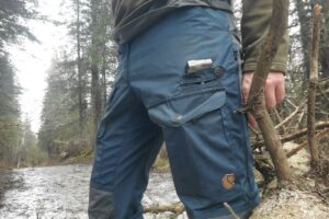 A closeup of a unique pocket on a pair of pants.