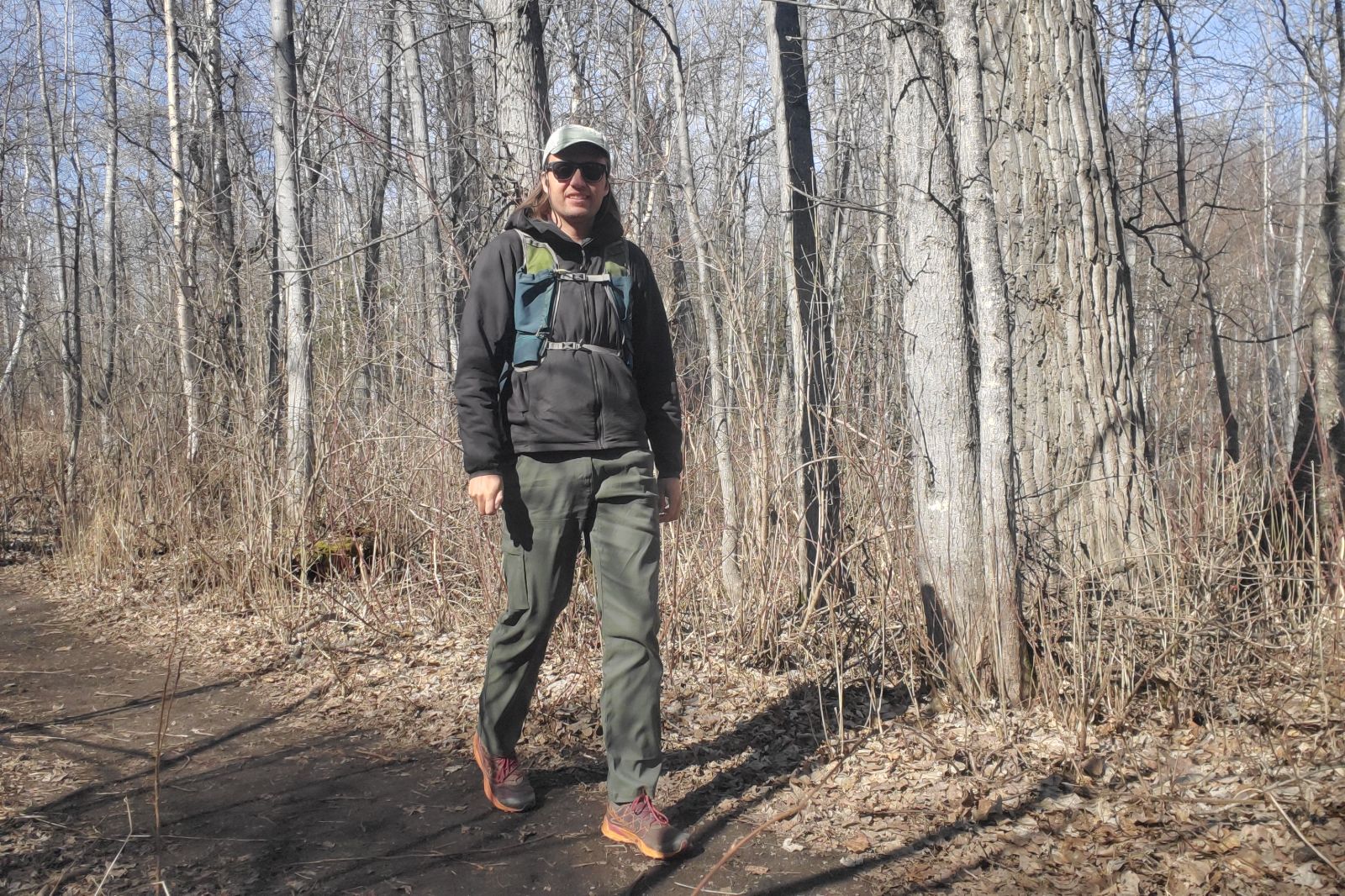 A man hikes along a trail in spring.
