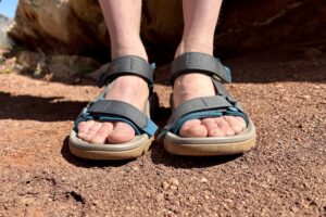 Close up image of a person's feet in a pair of hiking sandals from the front