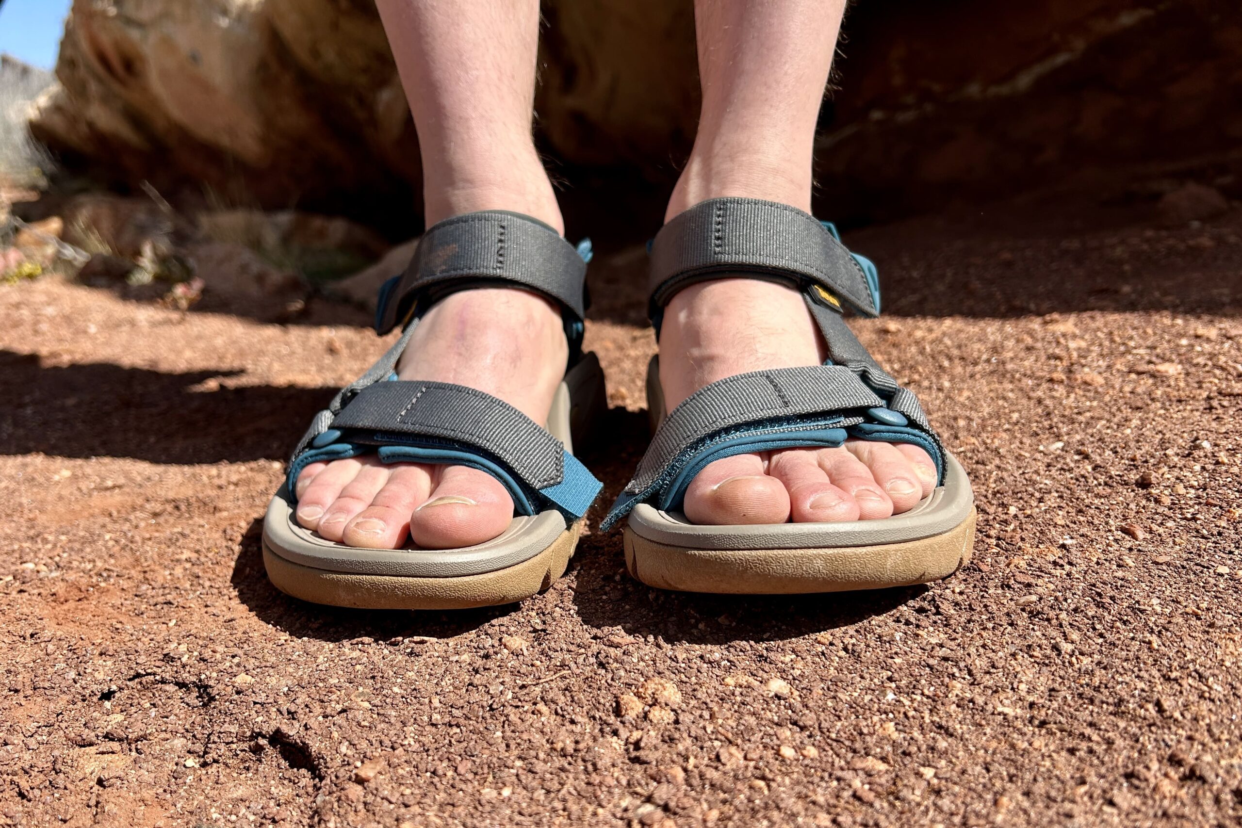 Close up image of a person's feet in a pair of hiking sandals from the front