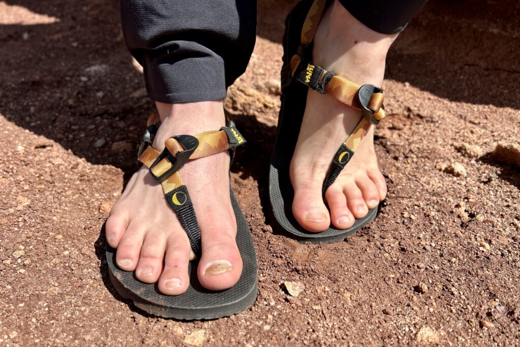 Close up image of a person wearing a pair of sandals from the front