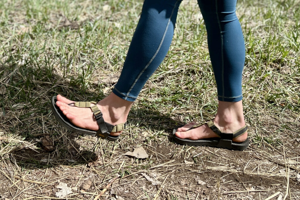 Profile image of a person walking in sandals and leggings in a grassy setting.
