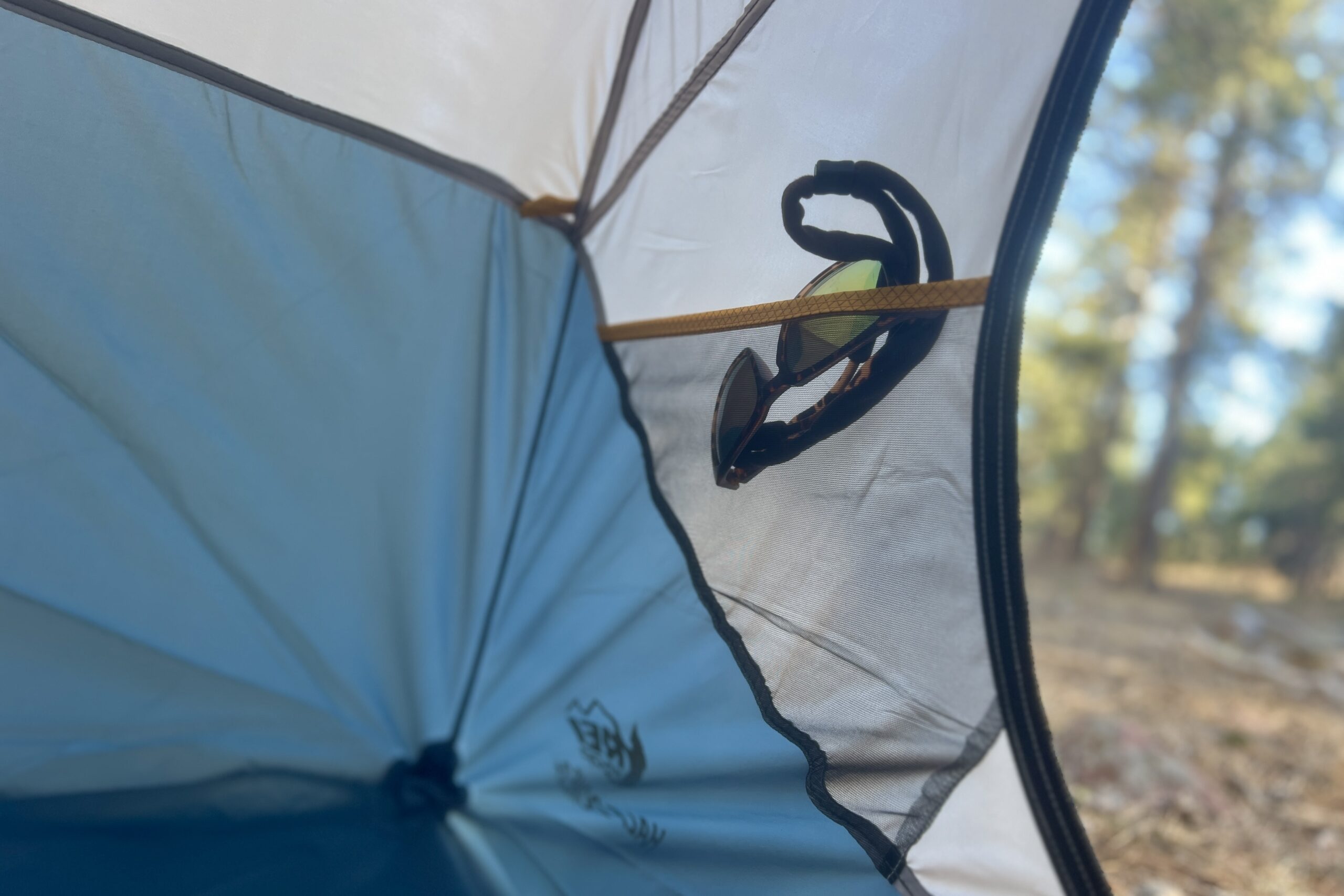 sunglasses in a tent's interior side pocket