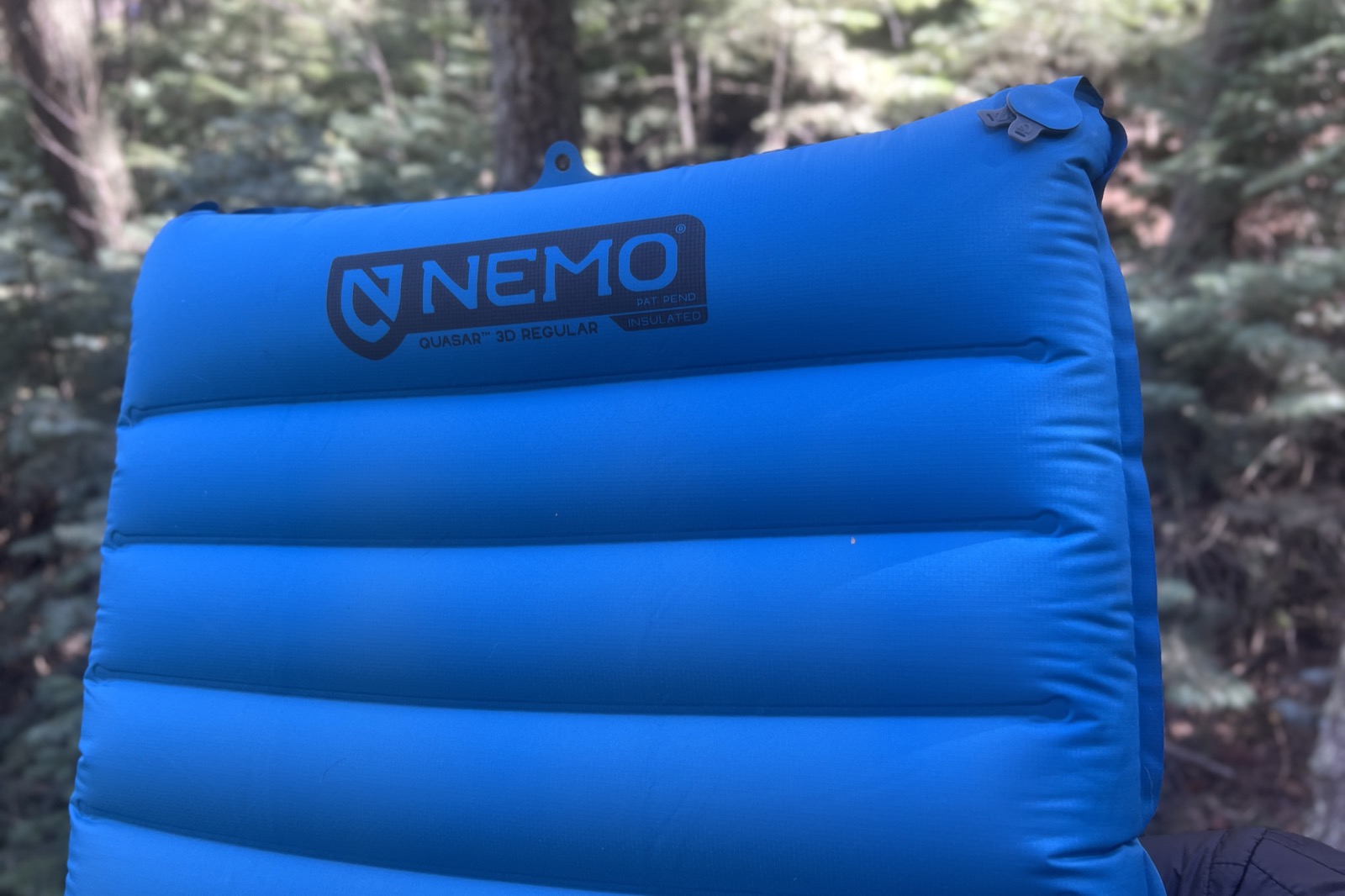 a closeup of the top of a blue sleeping pad
