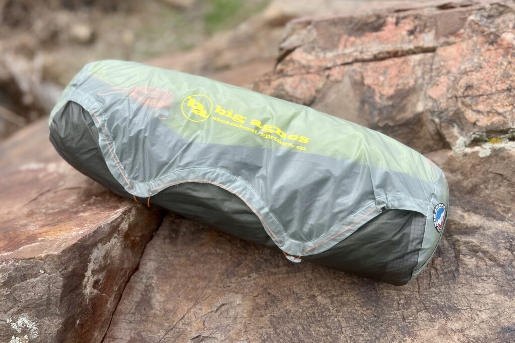 the big agnes tiger wall packed in its stuff sack sitting on a rock