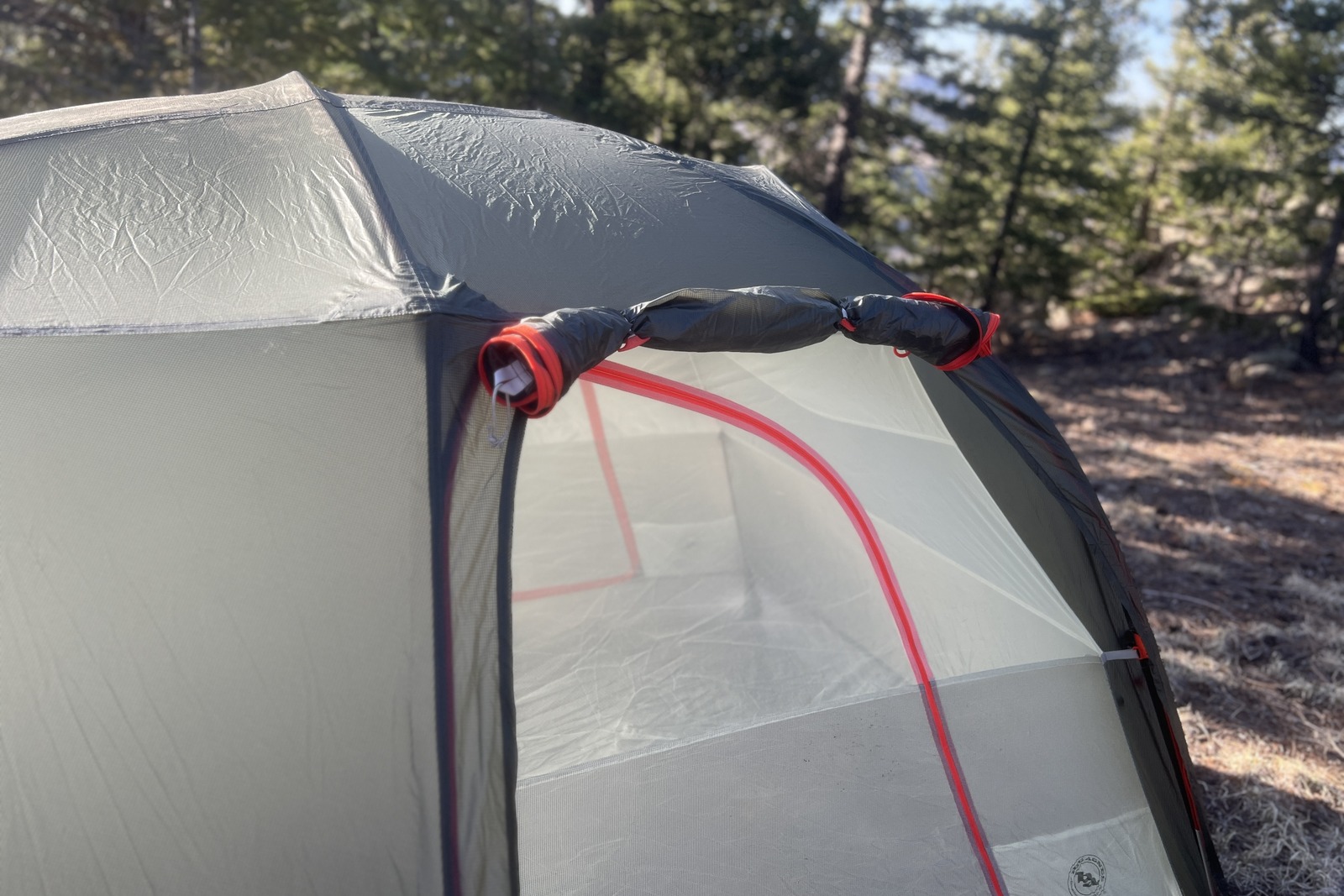 a close up of the awning door rolled up on a tent
