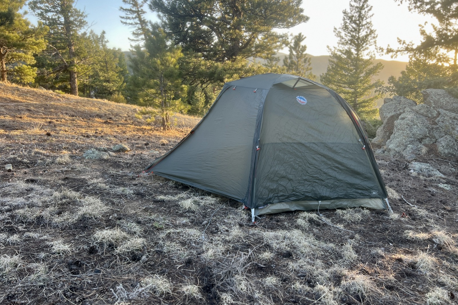 a big agnes tent sits pitched in a forest