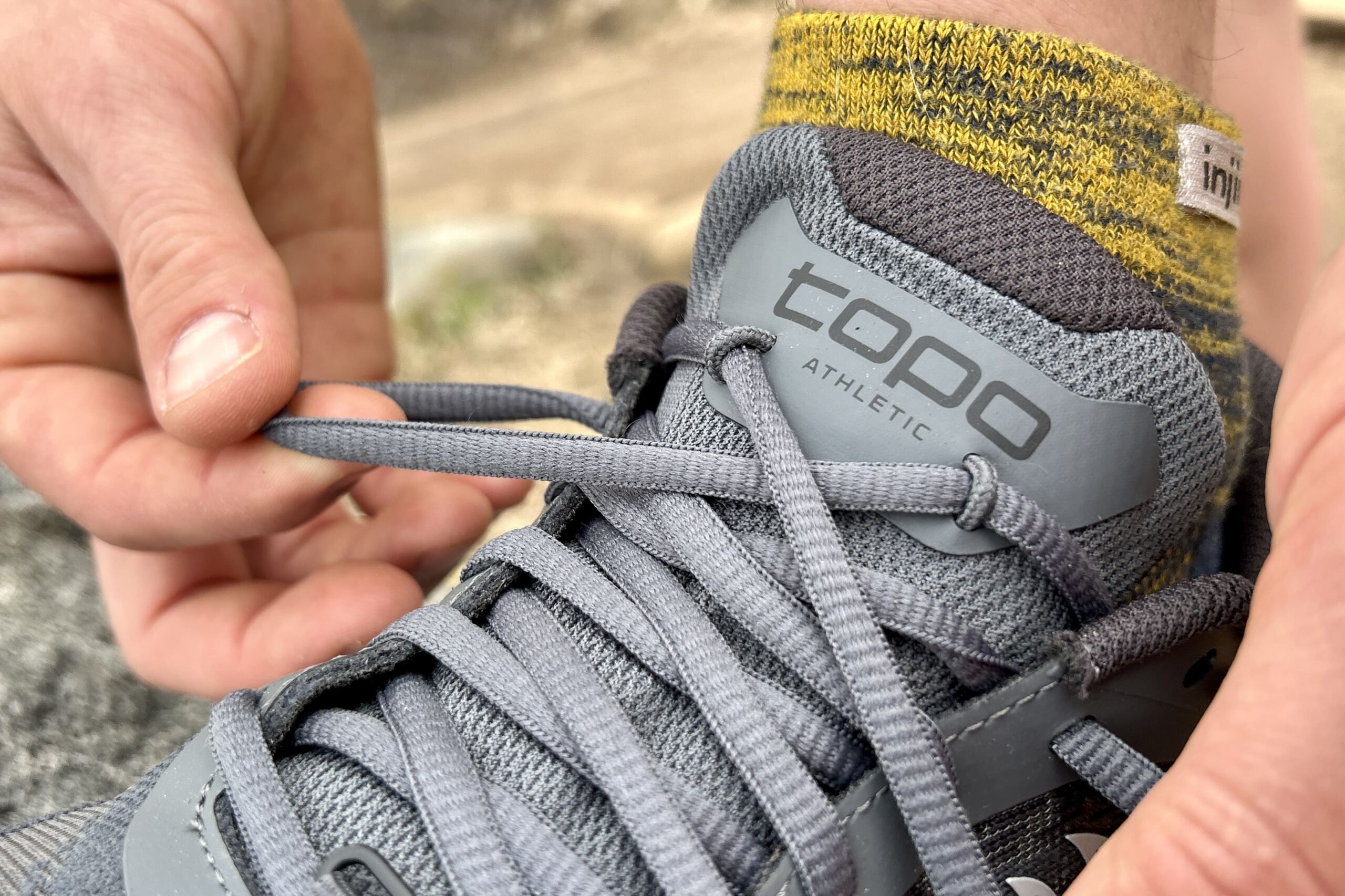 Close up of the lacing saddle on a pair of trail runners.