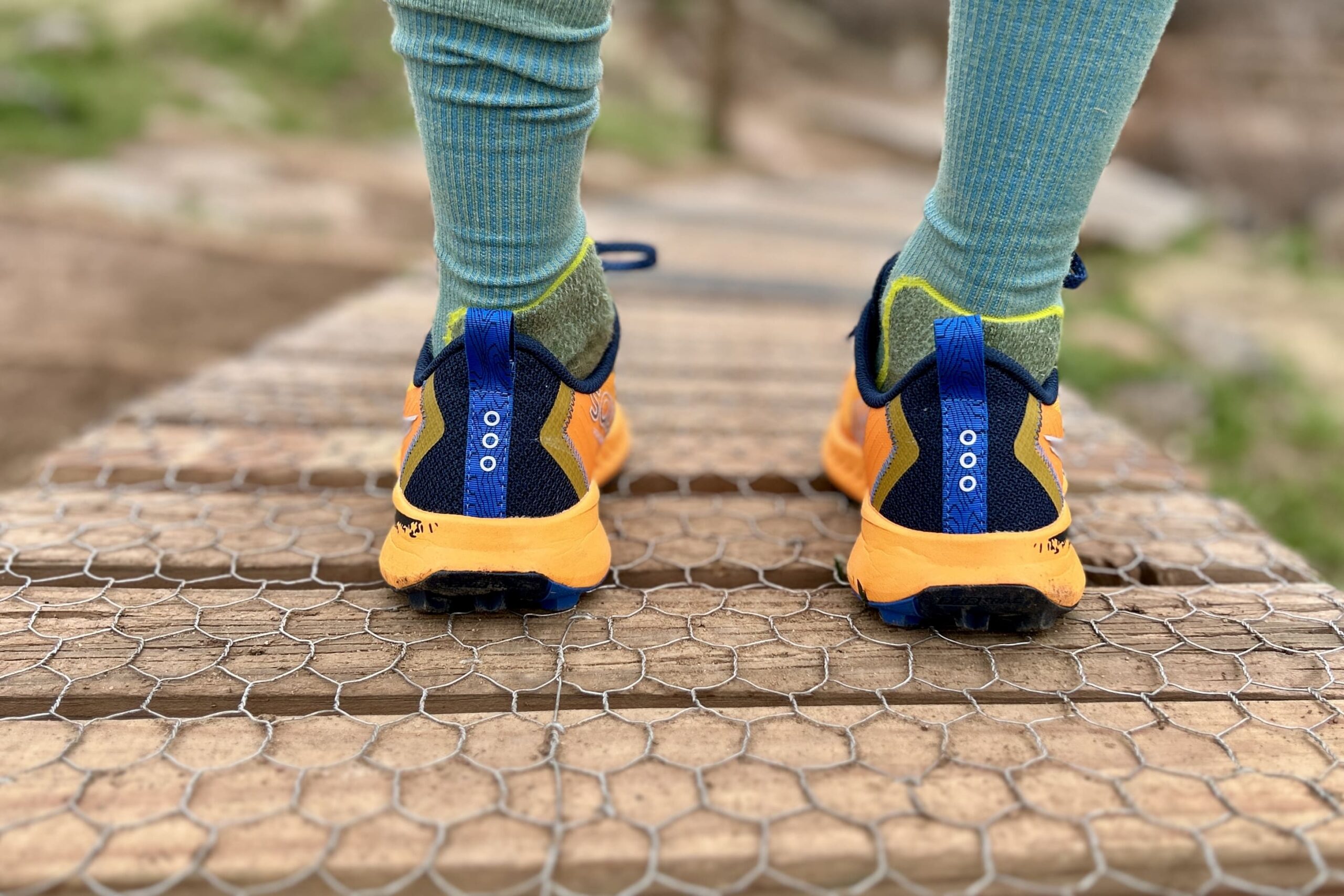 A pair of running shoes from behind, showing off the heel design.