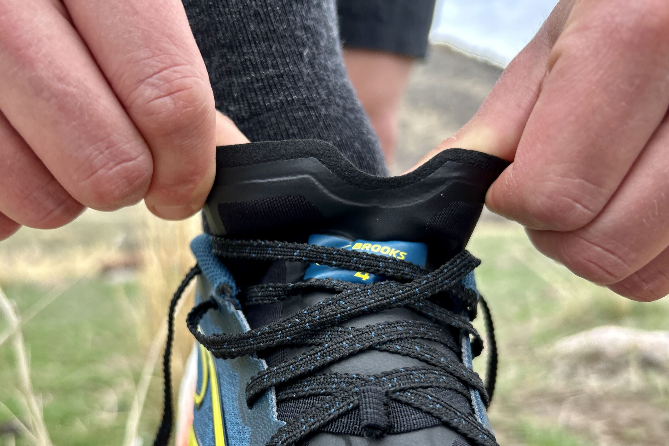 Close up of the cutout on the thin tongue on a pair of trail running shoes