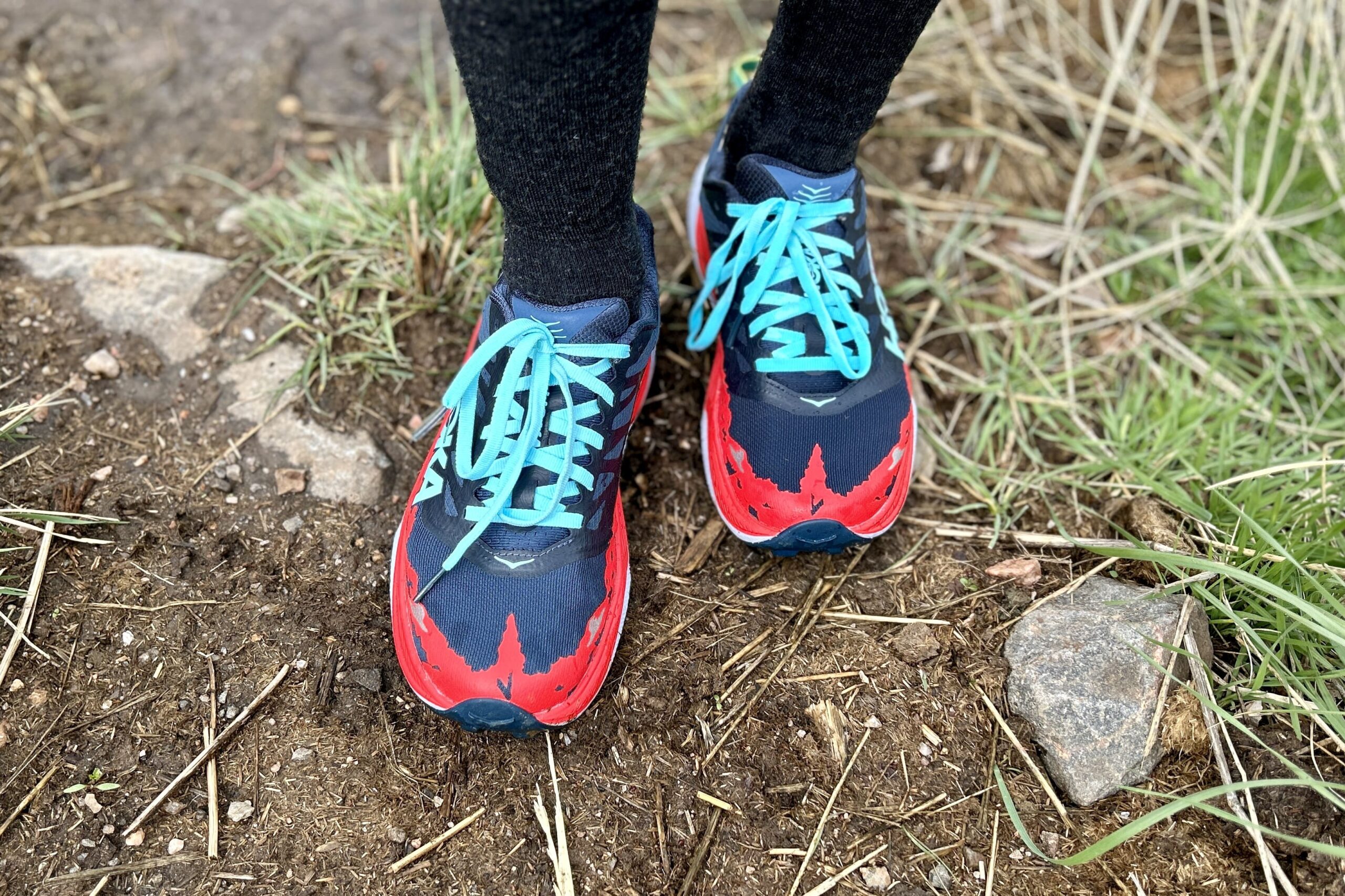 Top-down image of a pair of trail running shoes.