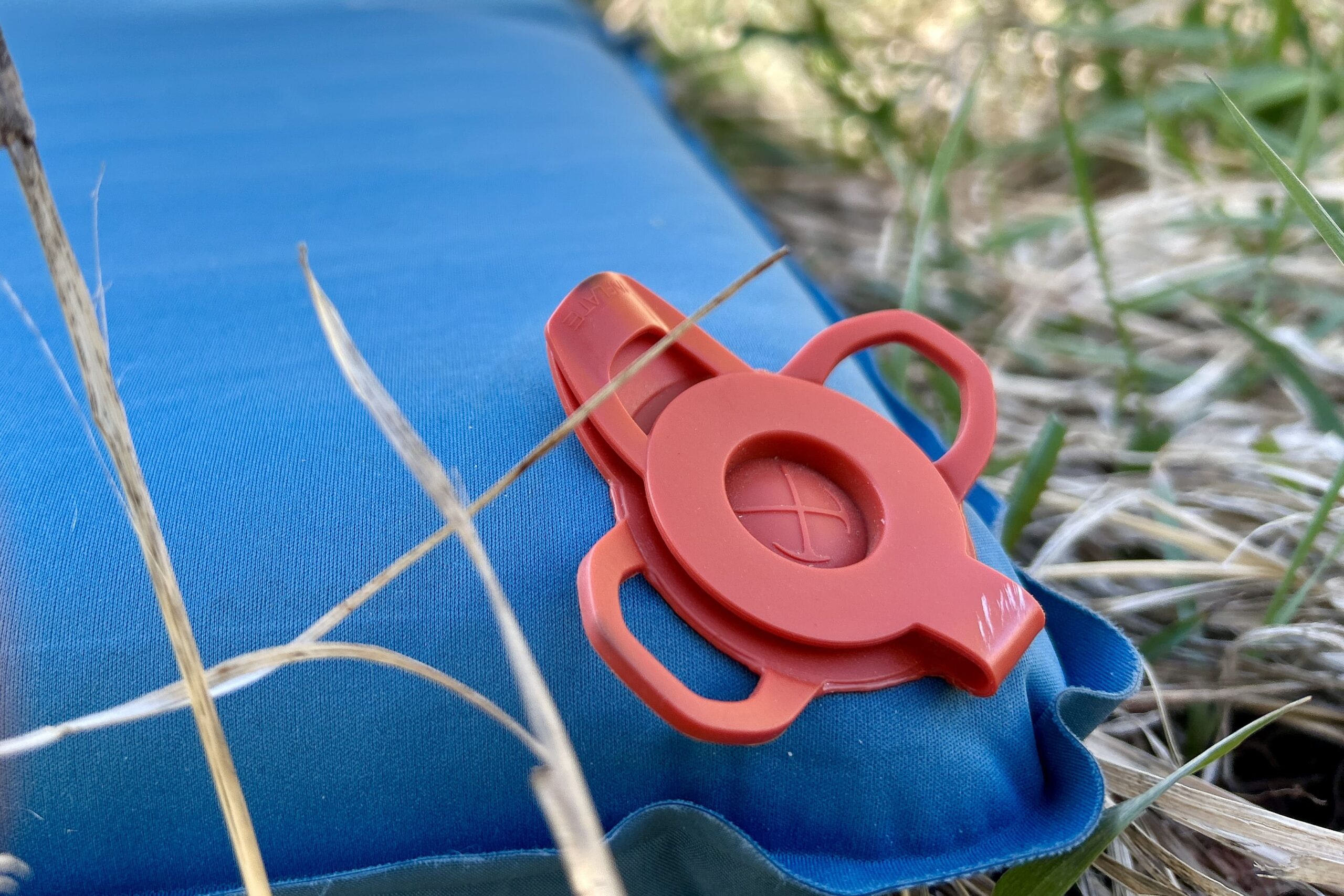 Close-up image of the inflation valve on a sleeping mattress.
