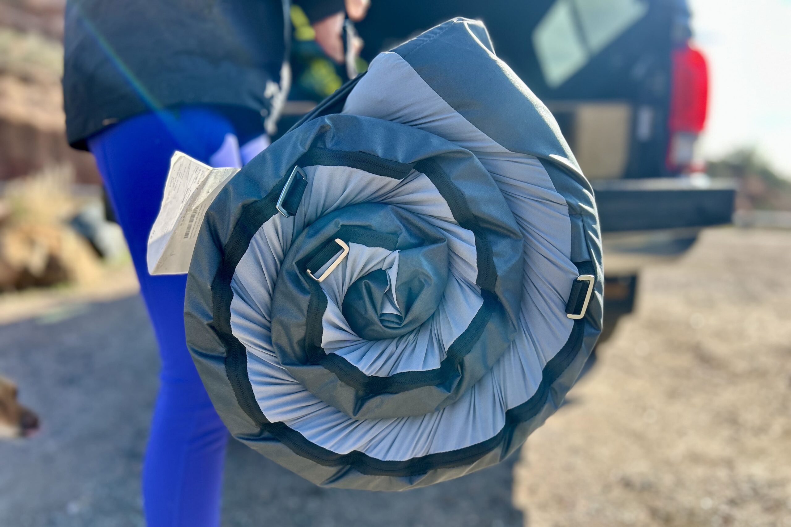 Close up image of a camping mattress rolled up tightly into a spiral