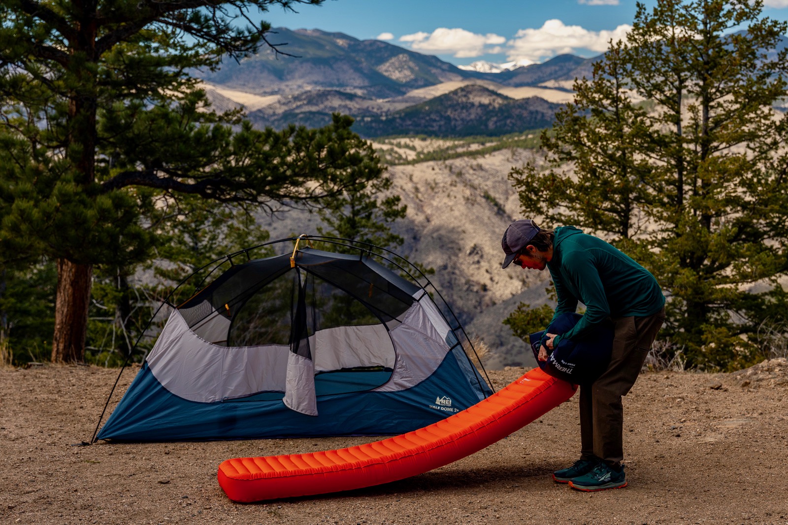 a hiker pumping air into a sleeping pad with a pump sack